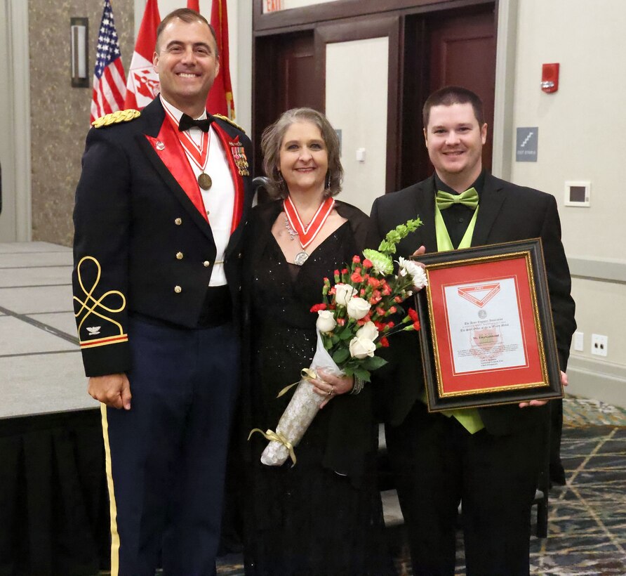 Tina Gatewood, U.S. Army Corps of Engineers, Mobile District customer service payroll representative, poses for a photo with USACE Mobile District Commander Col. Jeremy Chapman and her son Austin at the Mobile District Ball, May 9, 2023, Mobile, Alabama. Gatewood received the Steel de Fleury Medal. The de Fleury Medal is named after French engineer Francois Louis Tesseidre de Fleury and is one of the highest honors you can receive in the Corps. (U.S. Army photo by Chuck Walker)