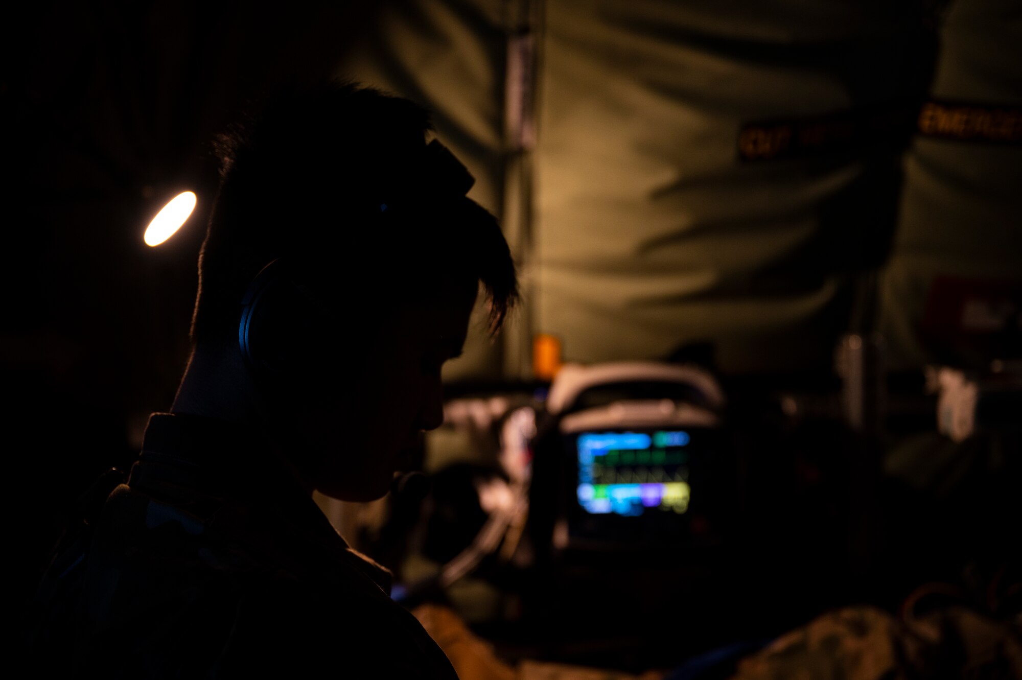 An Airman stands by a heart rate monitor