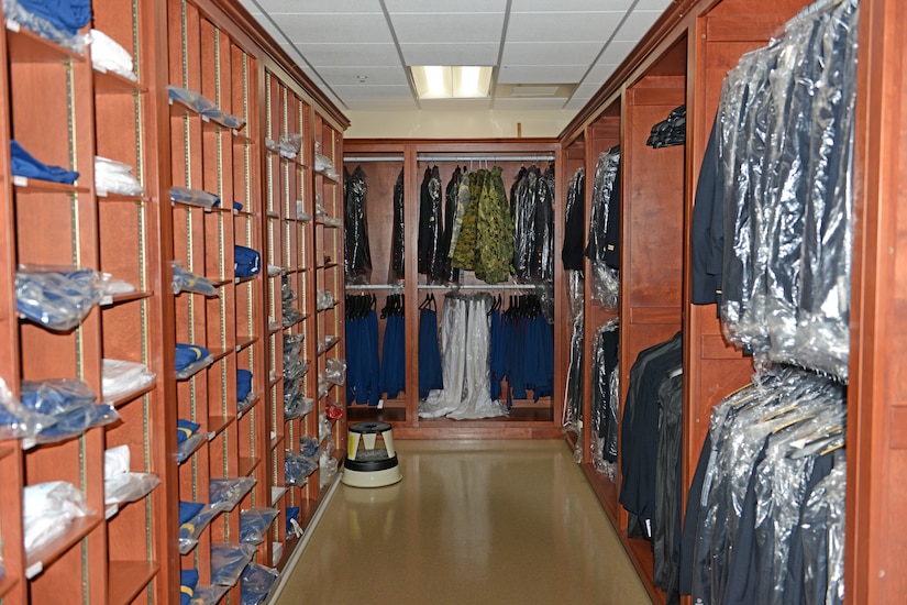 A large room holds cubicles and closets for clothing.