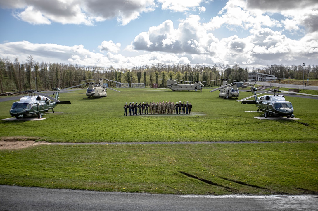 HMX-1, the Presidential Helicopter Squadron, for a group photo in Ireland, Friday, April 14, 2023. The Combat Aviation Brigade, 1st Armored Division helped support POTUS by providing transportation to the secret service, staff, and press while on his visit to Ireland. 1AD CAB is among other units assigned to the 4ID, proudly working alongside NATO allies and regional security partners to provide combat-credible forces to V Corps, America's forward-deployed corps in Europe. (U.S. Army photo by Spc. William Thompson)