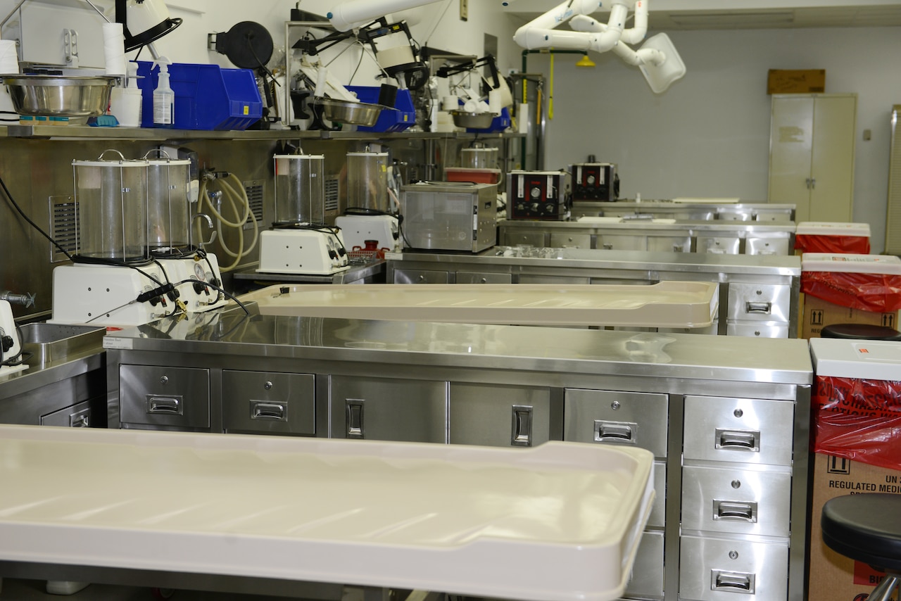 Steel cabinets are set up beside large basins and other scientific equipment.