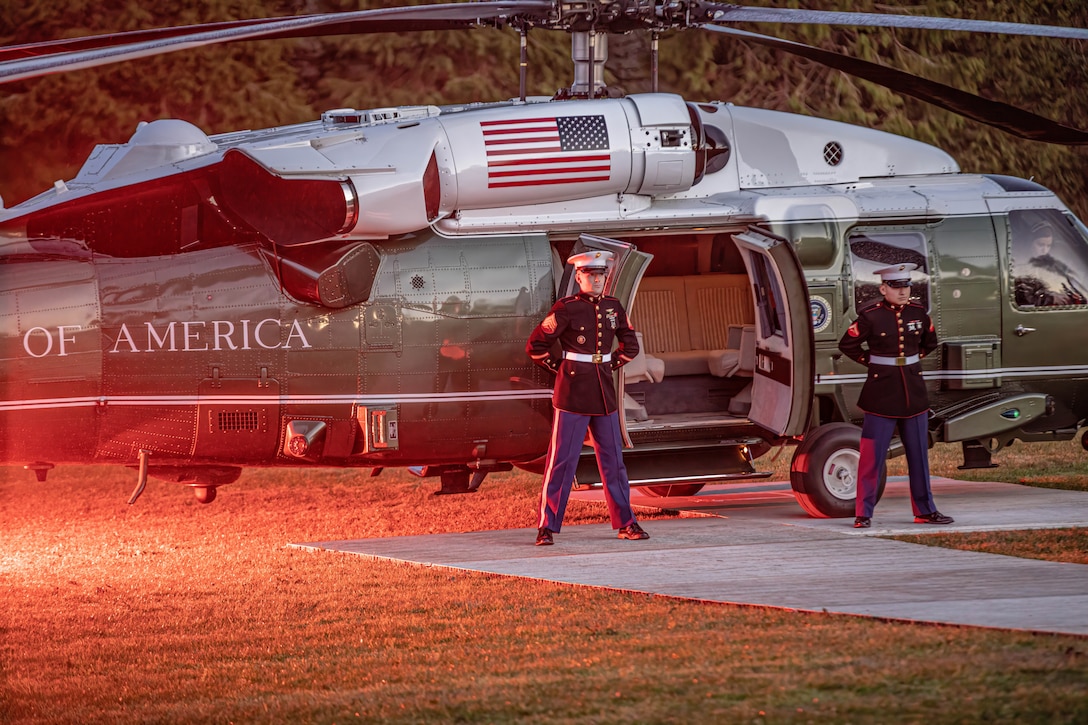 Two U.S. Marines, Assigned to HMX-1, Presidential Helicopter Squadron, prepare to transport U.S. President, Joe Biden during his visit to Ireland to celebrate the 25th anniversary of the Good Friday Agreement, County Mayo, Ireland, Friday, April 14, 2023. The Combat Aviation Brigade, 1st Armored Division helped support POTUS by providing transportation to the secret service, staff, and press while on his visit to Ireland. 1AD CAB is among other units assigned to the 4ID, proudly working alongside NATO allies and regional security partners to provide combat-credible forces to V Corps, America's forward-deployed corps in Europe. (U.S. Army photo by Spc. William Thompson)