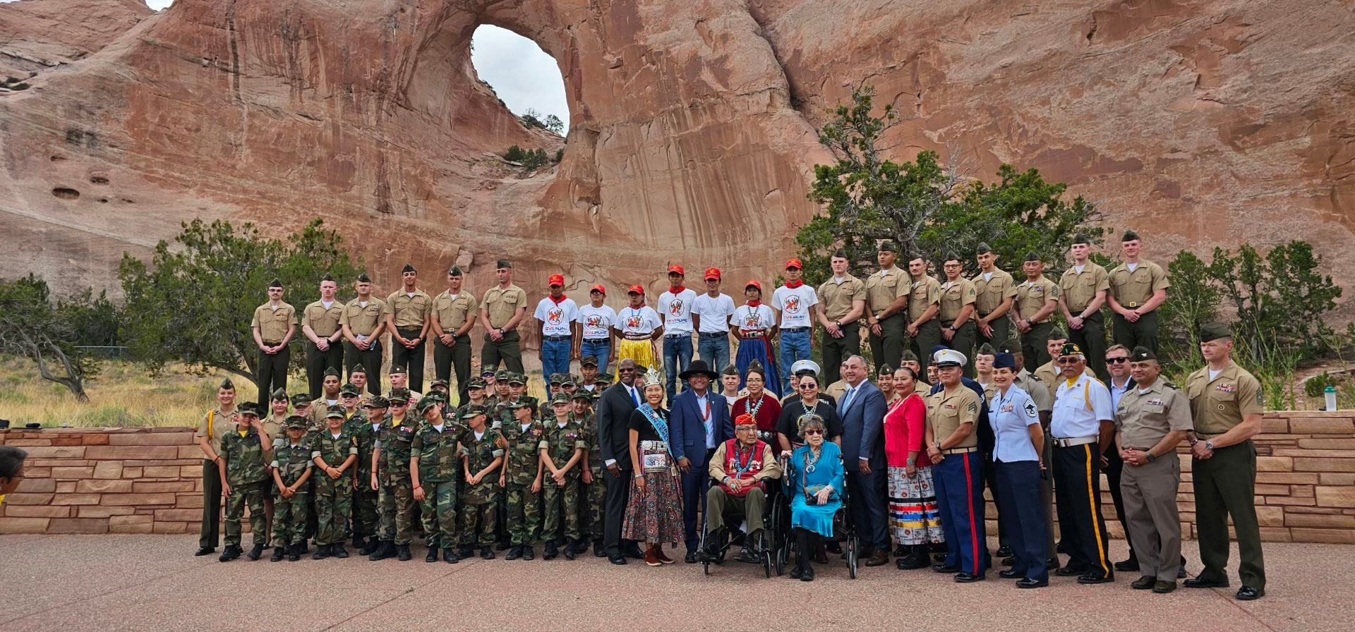 Group photo after the Navajo Code Talker’s Award Ceremony. Pictured: Master Gunnery Sgt. Clayton Hill; NCM Director Vince Houghton; USD (Intelligence & Security) Ronald Moultrie; USD (Personnel & Readiness) Gilbert Cisneros; DOD personnel; Marine Corps Junior ROTC; Navajo dignitaries; code talker Peter McDonald.