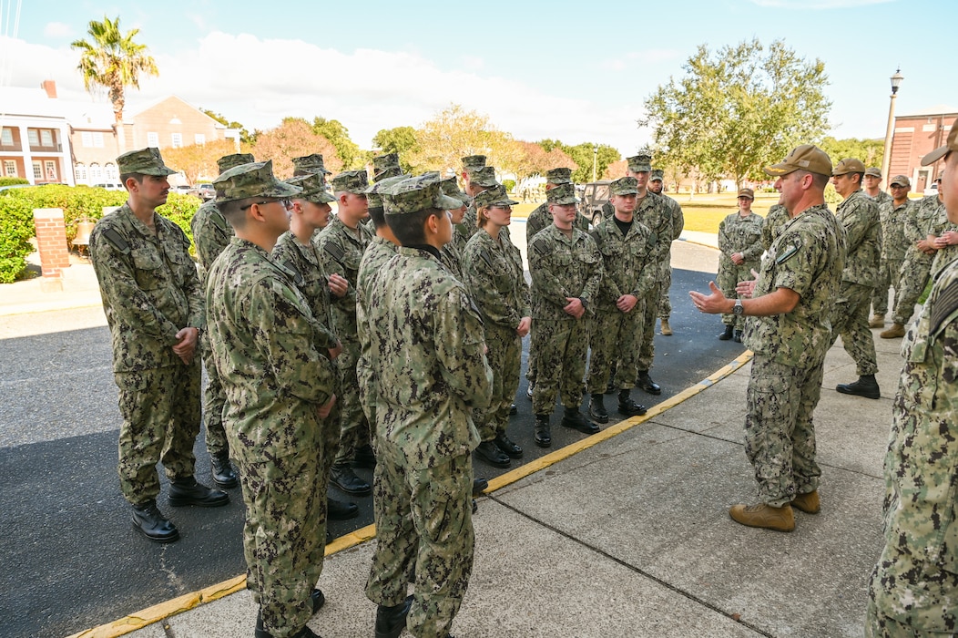 Capt. Chris Bryant, commanding officer the Center for Information Warfare Training, spoke to  Information Warfare Training Command Corry Station Sailors who supported the installation of PCTE Node Phoenix, the first PCTE Node to be installed on a Navy training installation, prior to presenting them with command coins as a token of appreciation for their hard work.