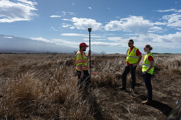 The U.S. Army Corps of Engineers, temporary housing, mission specialist, Anne Wurtenberger and mission manager Jeff McCullick visit with surveyor Stephen Caldwell at a proposed temporary housing site map. (U.S. Army photo by Brigida I. Sanchez)