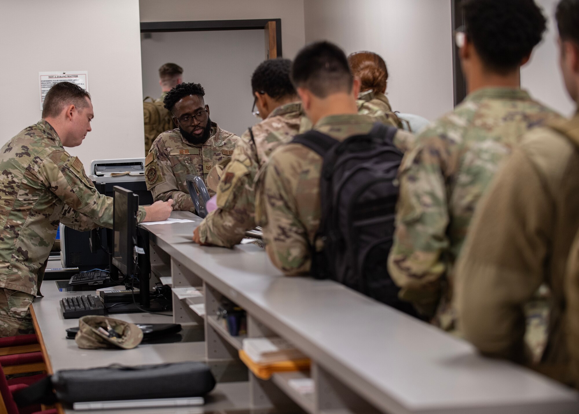 Airmen process through a deployment line