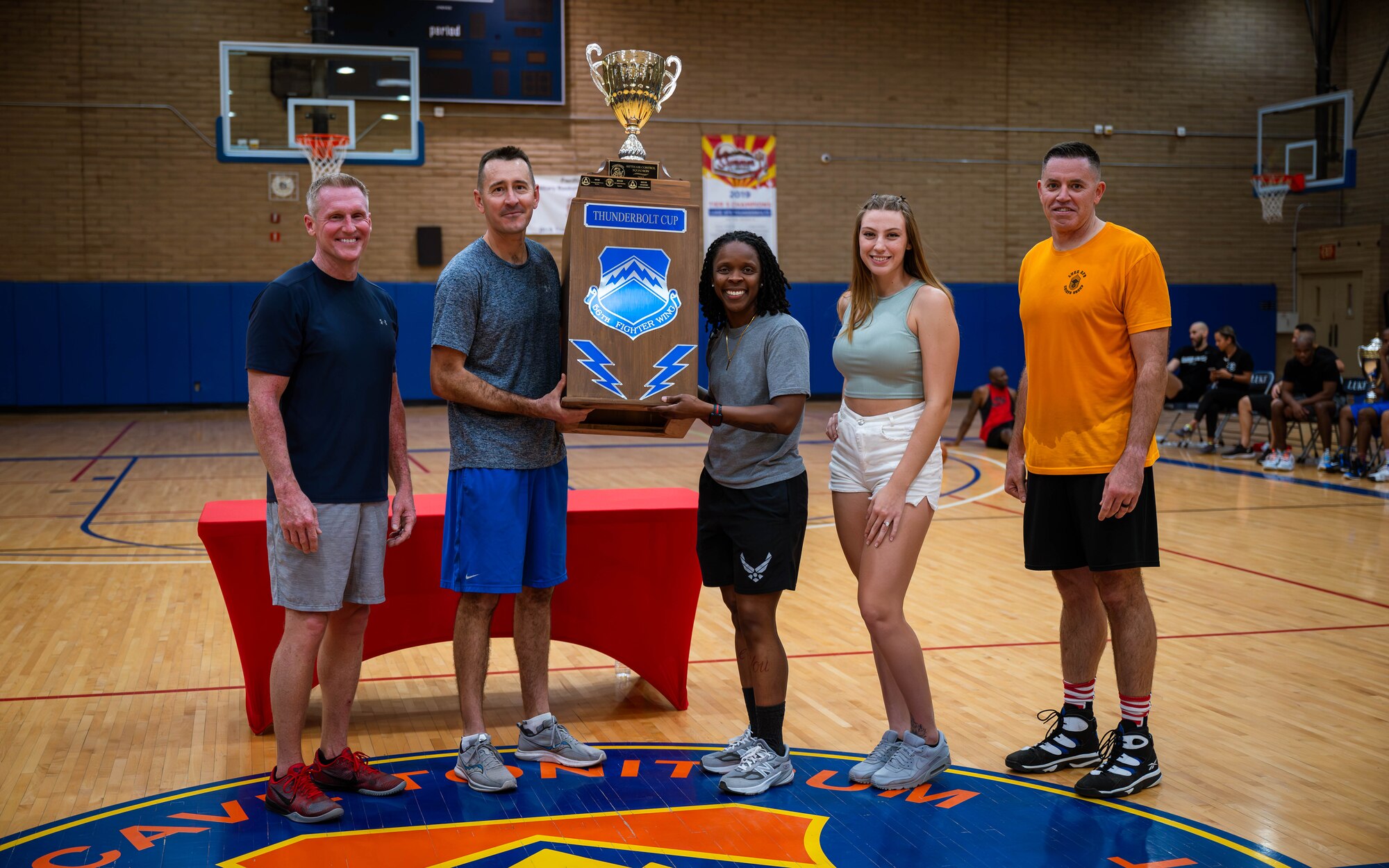 56th Fighter Wing Leadership presents the Thunderbolt Cup trophy to Logistics Readiness Squadron personnel