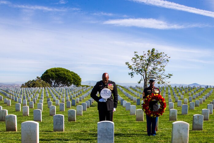 U.S. Marine Corps Brig. Gen. James A. Ryans, the Commanding General of Marine Corps Recruit Depot San Diego and Western Recruiting Region and Sgt. Maj. Oranjel Leavy, the Sergeant Major of Marine Corps Recruit Depot and Western Recruiting Region, pause for a moment of silence for former Sergeant Major of the Marine Corps, Sgt. Maj. Leland D. Crawford, at Fort Rosecrans National Cemetery, San Diego, California, Nov. 10, 2023. The wreath laying ceremonies are a continuing part of the Marine Corps birthday tradition and honor the service to Corps and Country. (U.S. Marine Corps photo by Sgt. Sydney Smith)