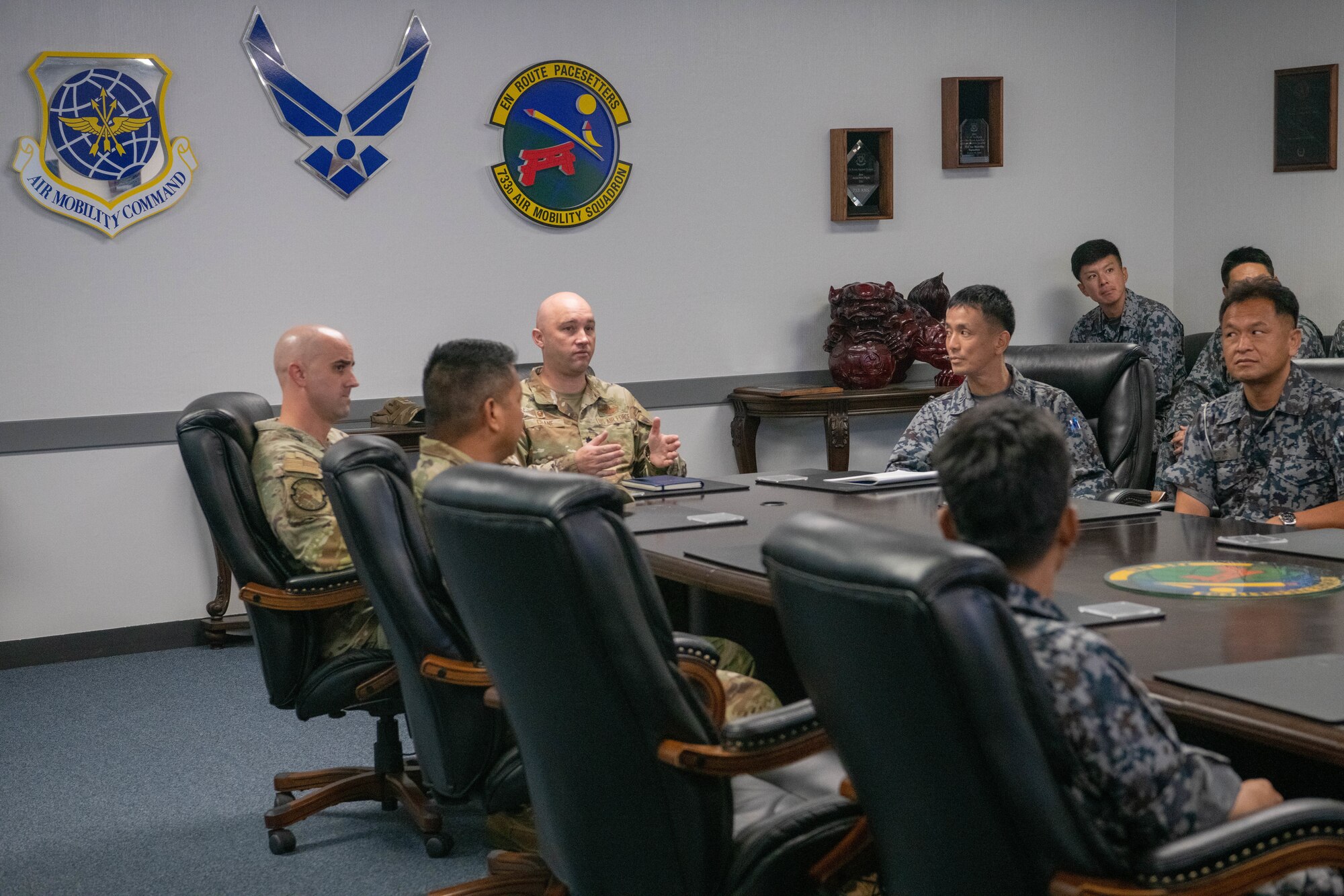 U.S. Air Force 733rd Air Mobility Squadron and Japan Air Self-Defense Force members sit together to discus different operation tactics.