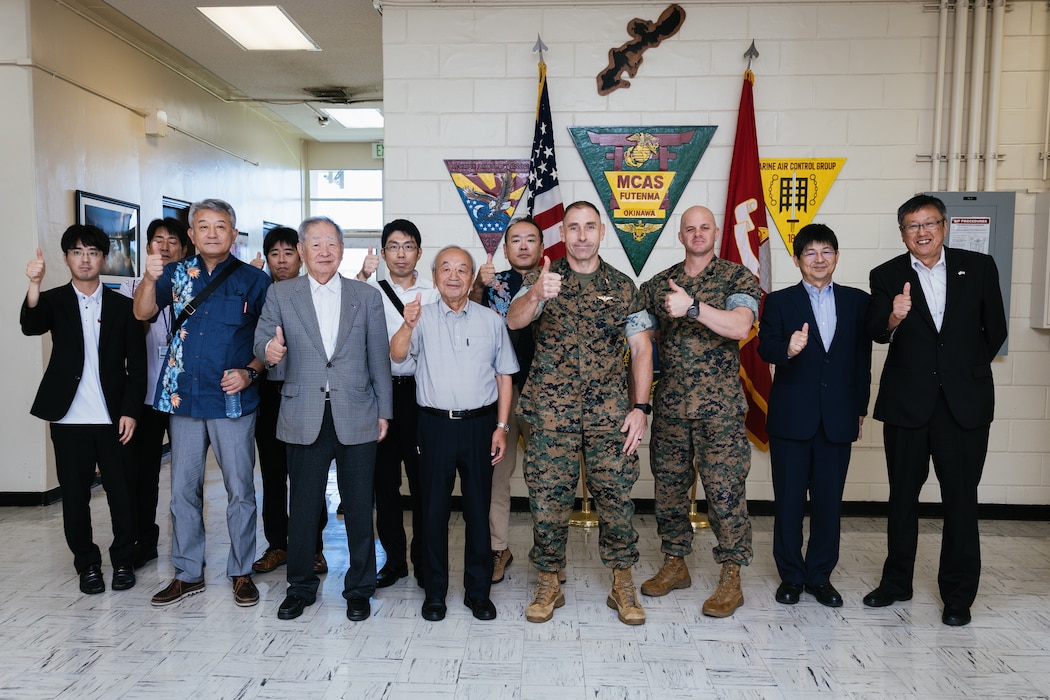 U.S. Marine Corps Col. William C. Pacatte, commanding officer of Marine Corps Air Station Futenma, and members of the Iwakuni Chamber of Commerce, pose for a group photo during their visit to MCAS Futenma on Nov. 1, 2023. The Iwakuni Chamber of Commerce visited MCAS Futenma to help fortify support for the Japan U.S. alliance and build insight into the mission and challenges faced by MCAS Futenma and the city of Ginowan; giving the Iwakuni Chamber of Commerce the opportunity to lend their knowledge and experience on establishing concrete working relationships between their own community and Marine Corps Air Station Iwakuni. (U.S. Marine Corps Photo by Sgt. Maximiliano Rosas)