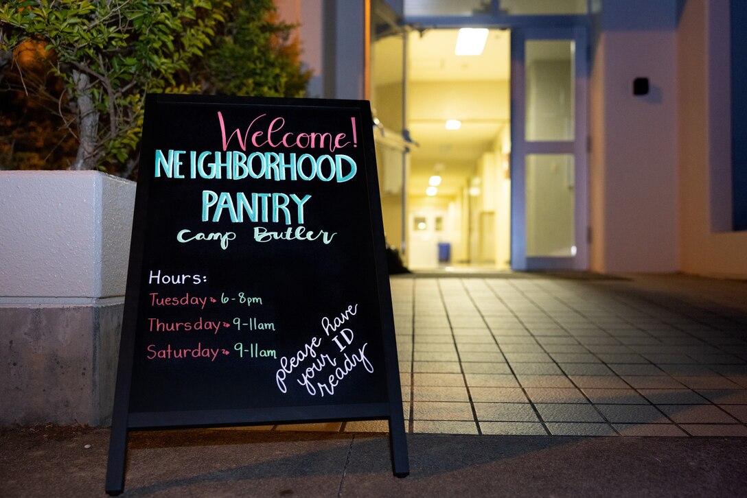 A sign is displayed outside during the opening day of the Neighborhood Pantry at the Camp Foster Chapel on Camp Foster, Okinawa, Japan, Nov. 7, 2023. The Neighborhood Pantry is a program that gives service members and their families temporary relief by providing food, cleaning supplies, and other household essentials during difficult times. (U.S. Marine Corps photo by Cpl. Thomas Sheng)