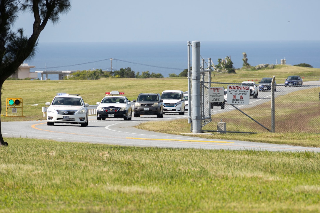 U.S. Marines with the Provost Marshal’s Office, Headquarters and Support Battalion, Marine Corps Installations Pacific, escort members of the Ginowan Police Department through the tsunami evacuation route during an emergency tsunami evacuation drill on Marine Corps Air Station Futenma, Okinawa, Japan, Nov. 8, 2023. U.S. Marines with the PMO, H&S Battalion, MCIPAC, and members of the Ginowan Police Department participated in a tsunami evacuation drill to exercise agreements between MCAS Futenma and the city of Ginowan. The drill helped to build trust and relationships within the community, which will ensure readiness and accessibility to the base in the event of a natural disaster. (U.S. Marine Corps photo by Cpl. Alex Fairchild)