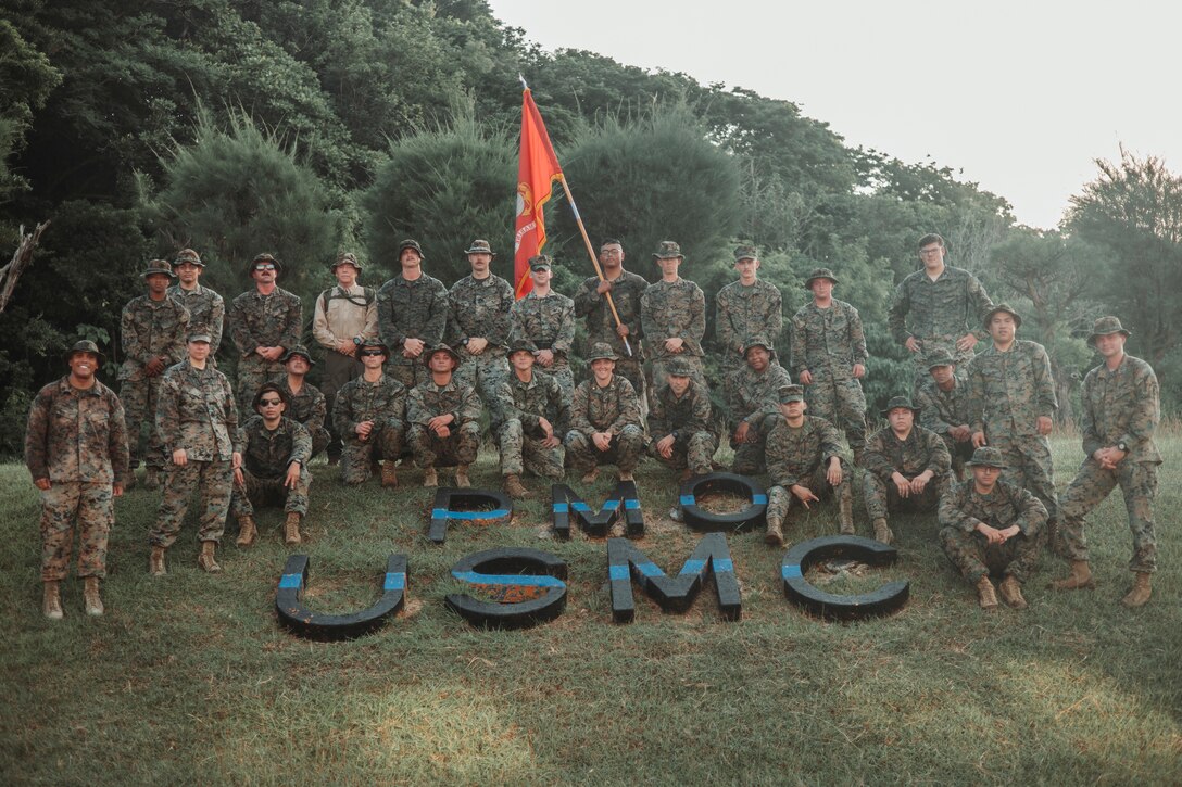 U.S. Marines with the Provost Marshal’s Office, Headquarters and Support Battalion, Marine Corps Installations Pacific, pose for a group photo after conducting a five-kilometer hike on Camp Foster, Okinawa, Japan, Nov. 9, 2023. The hike was conducted in celebration of the Marine Corps’ 248th birthday, as well as to increase morale and readiness within the unit.  (U.S. Marine Corps photo by Cpl. Alex Fairchild)
