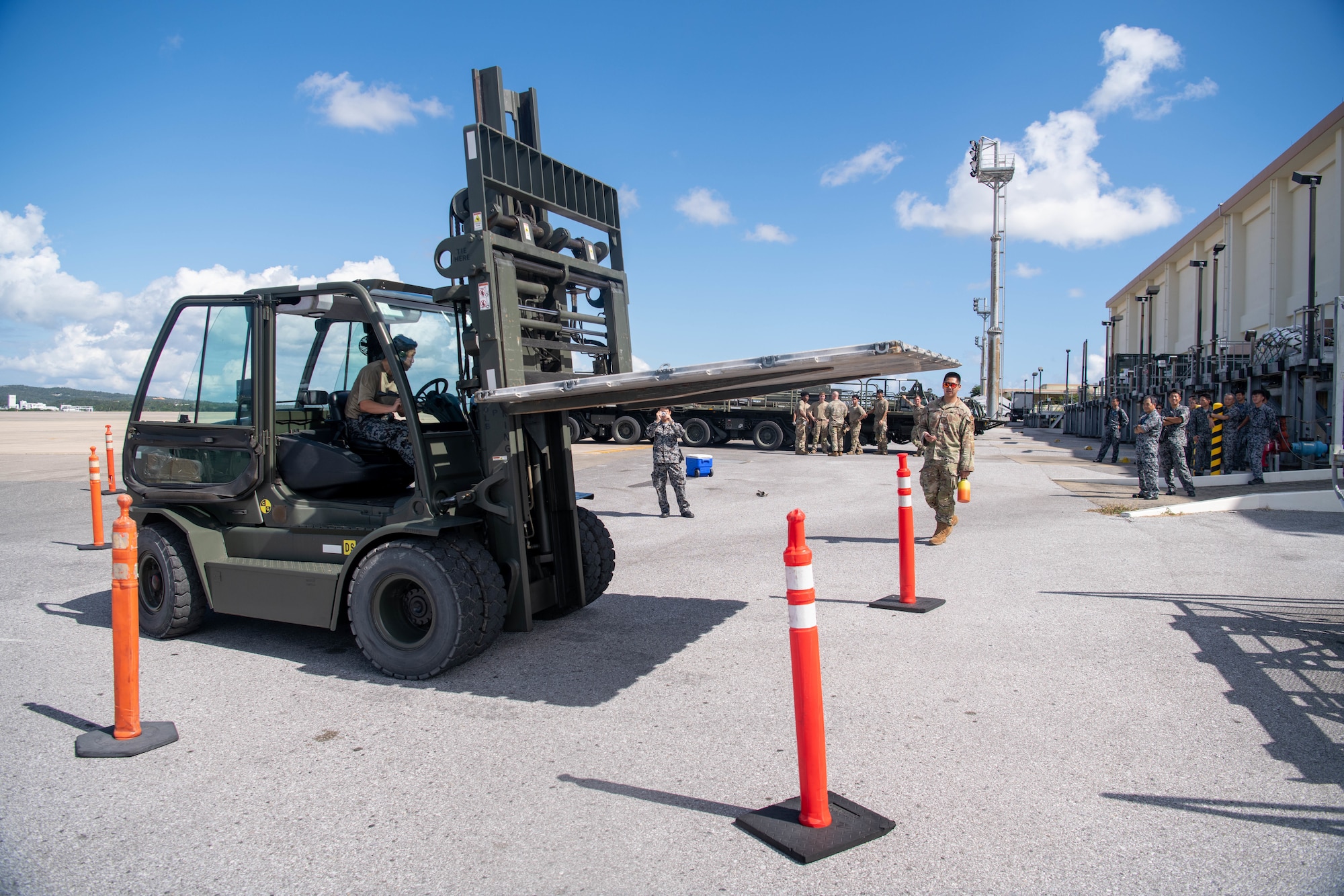 Japan Air Self-Defense Force and and U.S. Air force work together during a forklift exercise.