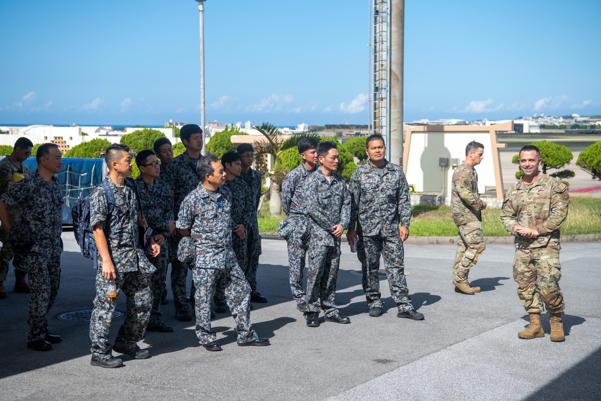 U.S. Air Force Tech. Sgt. Brandon Metz guides members of the Japan Air Self-Defense Force during a tour of Kadena