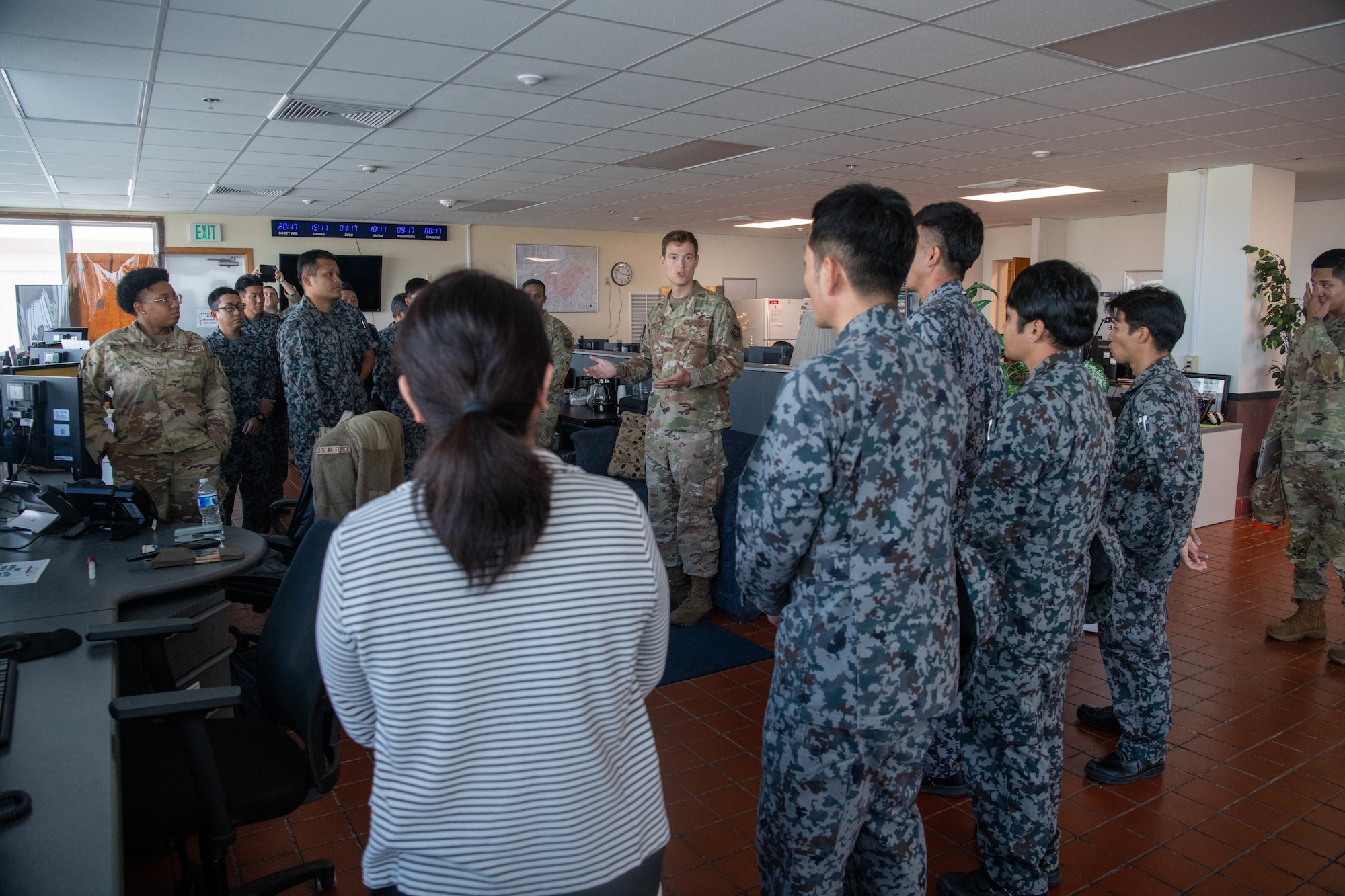Staff Sgt. James Bullard shows Japan Air Self-Defense Force members Kadena's air terminal operations center