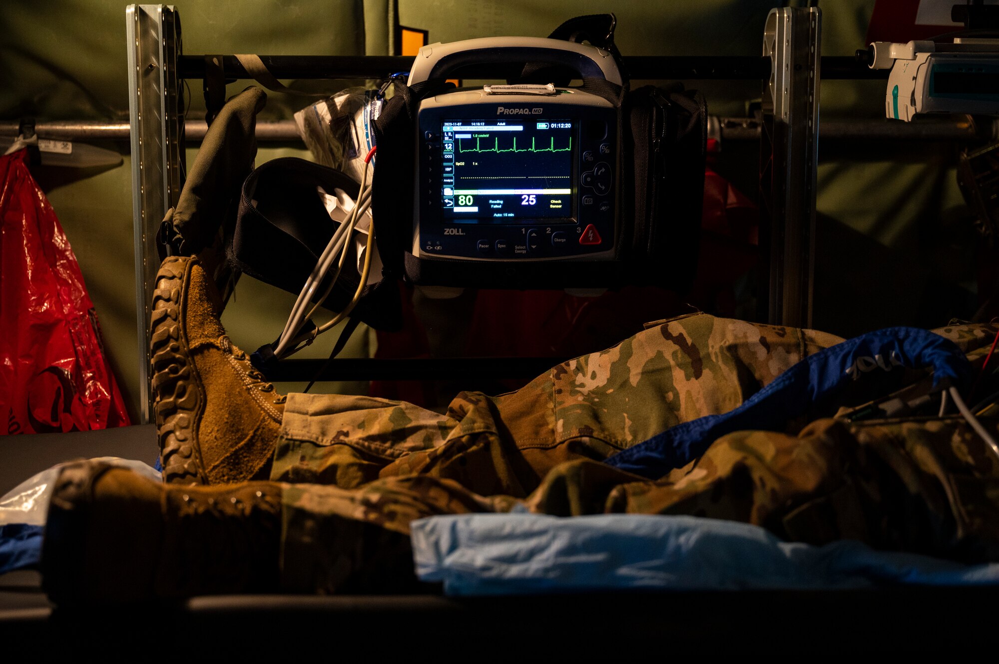 The legs of a patient next to a heartbeat monitor