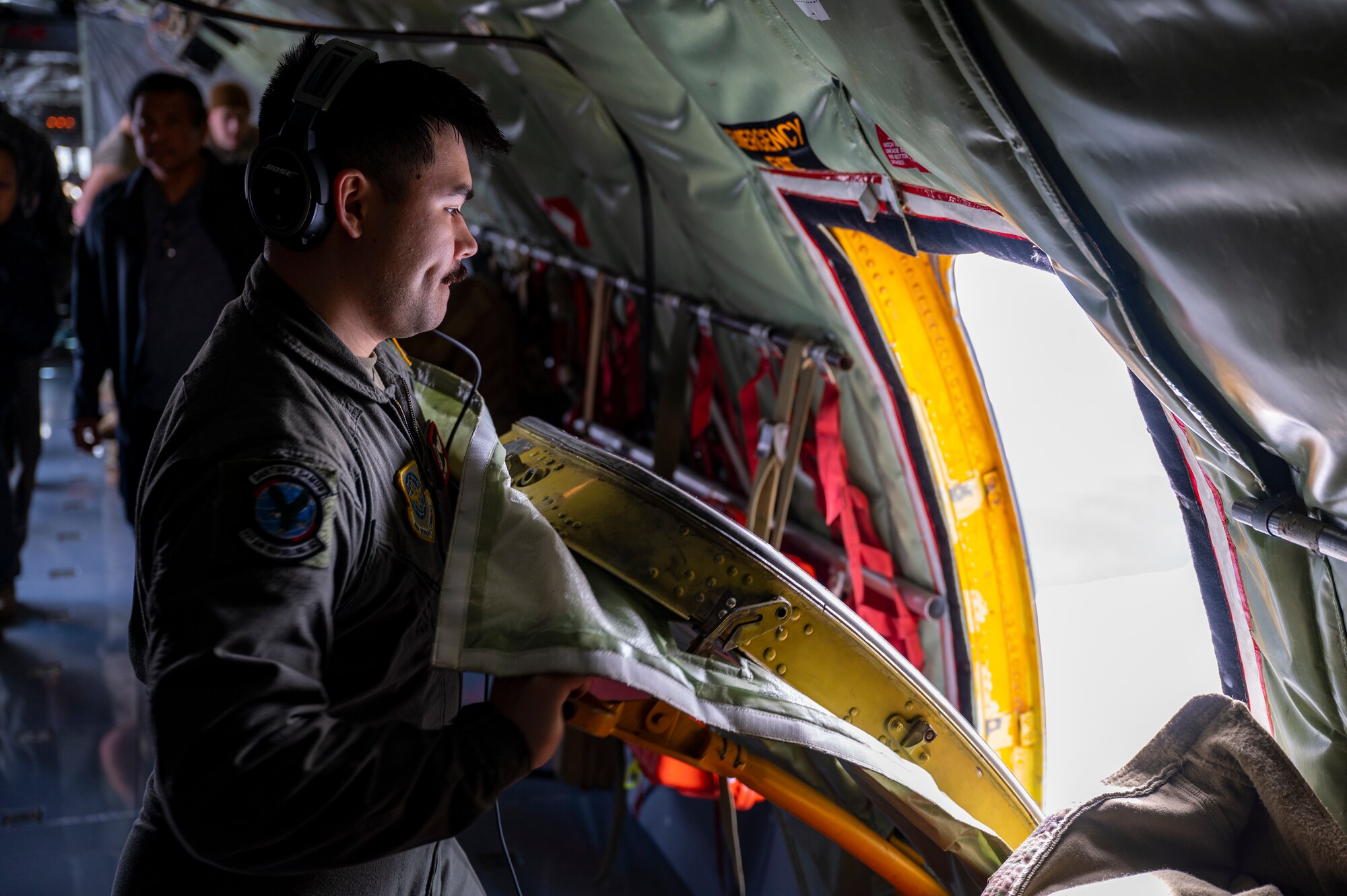 An Airman opening an aircraft door