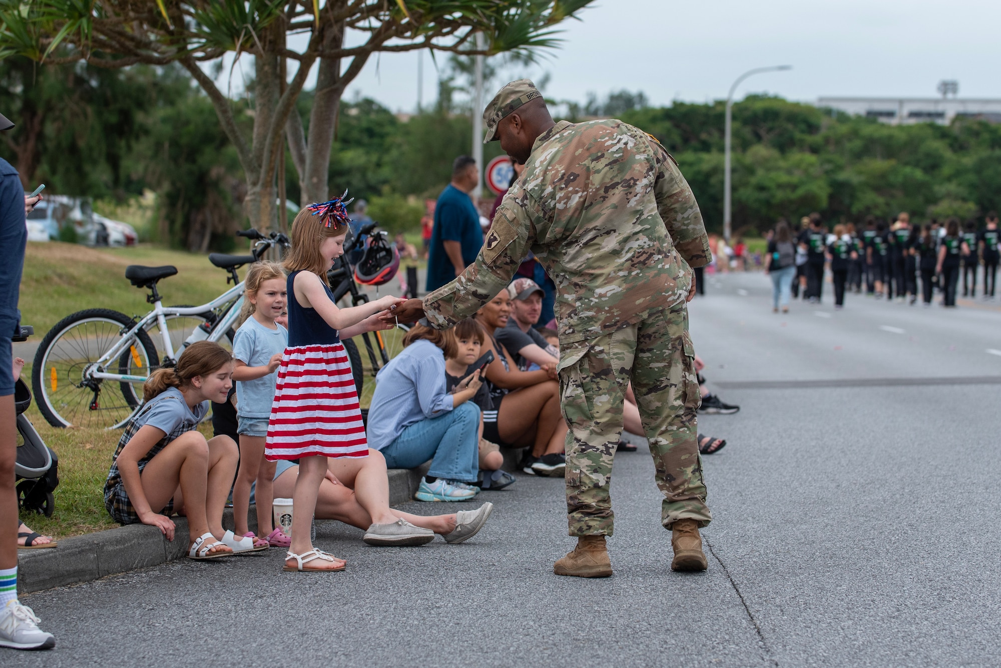 Service members hand out candy to spectators during Kadena Air Base's Veteran's day parade