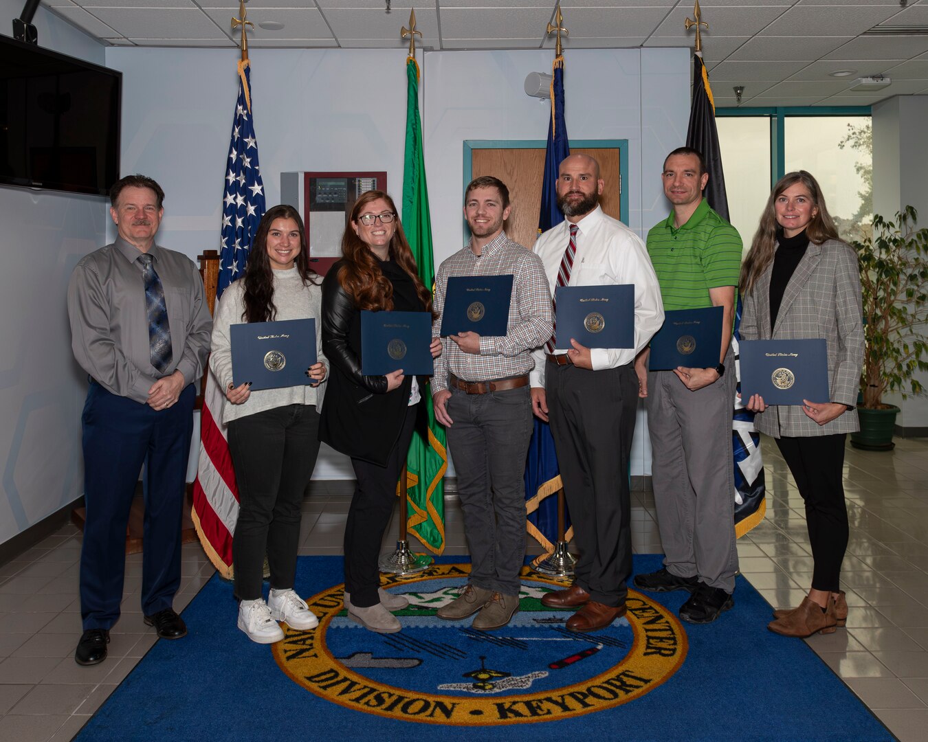 Naval Undersea Warfare Center Division, Keyport Deputy Technical Director Michael Slater celebrates with the inaugural graduates of the Naval Postgraduate School’s “Implementing Technology Change” certificate program.