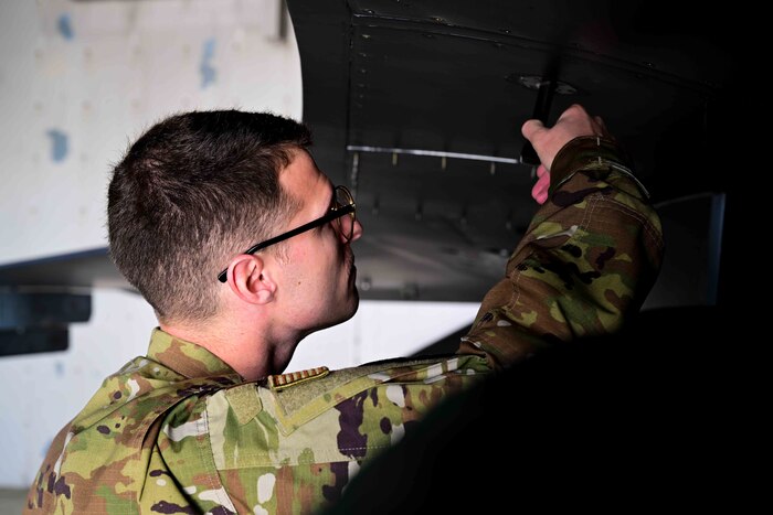 U.S. Air Force Staff Sgt. Trevor Koelsch, 555th Fighter Generation Squadron avionics craftsman, performs a routine aircraft maintenance check on an F-16 Fighting Falcon.