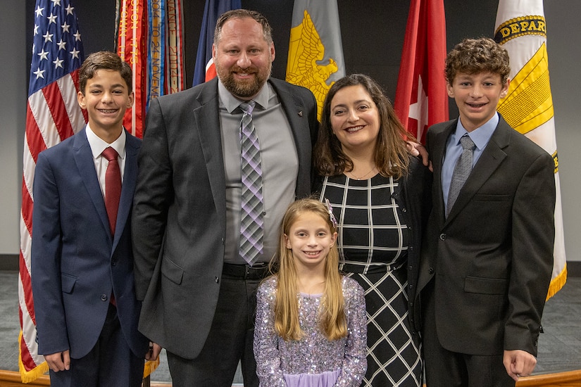 Ryan A. Busby, U.S. Army Financial Management Command deputy to the commanding general, poses with his wife Lisa, Defense Finance and Accounting Service accountant, and their children, Sam, Wes, and Emma during his Senior Executive Service induction ceremony at the Maj. Gen. Emmett J. Bean Federal Center in Indianapolis Nov. 2, 2023. Busby serves as the principal advisor to the USAFMCOM commanding general, ensuring the two-star command delivers precision, enterprise-wide financial operations to integrate, synchronize and sustain the battlefield through the Joint Strategic Area. (U.S Army photo by Mark R. W. Orders-Woempner)