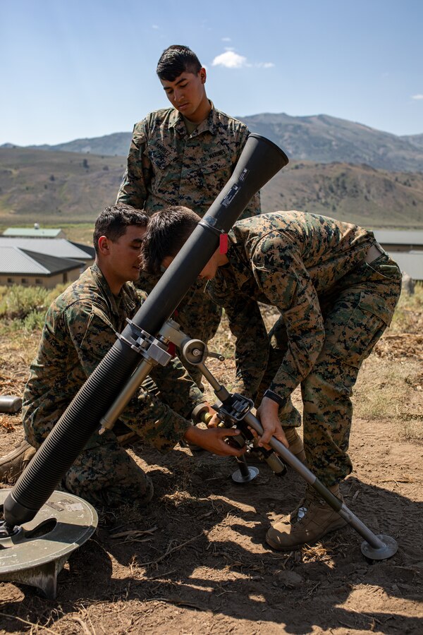 U.S. Marines with Weapons Company, 1st Battalion, 24th Marine Regiment, 4th Marine Division, Marine Forces Reserve, adjust the height of an M252A1 81mm mortar while conducting mortar training drills at Marine Corps Mountain Warfare Training Center, Bridgeport, Calif., July 27, 2022, for Mountain Training Exercise 4-22. MTX 4-22 offers a unique training experience for reserve Marines to prepare and develop an understanding of traversing a mountainous environment as they maintain their readiness. (U.S. Marine Corps photo by Cpl. Jonathan L. Gonzalez)