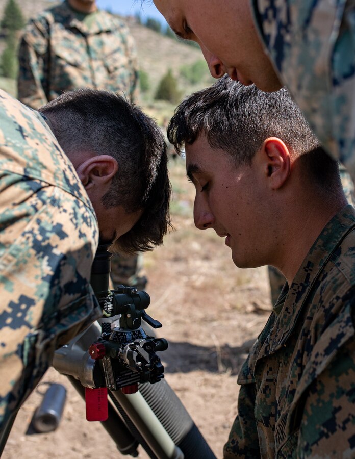U.S. Marines with Weapons Company, 1st Battalion, 24th Marine Regiment, 4th Marine Division, Marine Forces Reserve, look down an M67 mortar sight while conducting mortar drills at Marine Corps Mountain Warfare Training Center, Bridgeport, Calif., July 27, 2022, for Mountain Training Exercise 4-22. MTX 4-22 allowed reserve Marines to participate in mountain warfare operations for realistic combat training to facilitate increased readiness for the Marine Forces Reserve. (U.S. Marine Corps photo by Cpl. Jonathan L. Gonzalez)