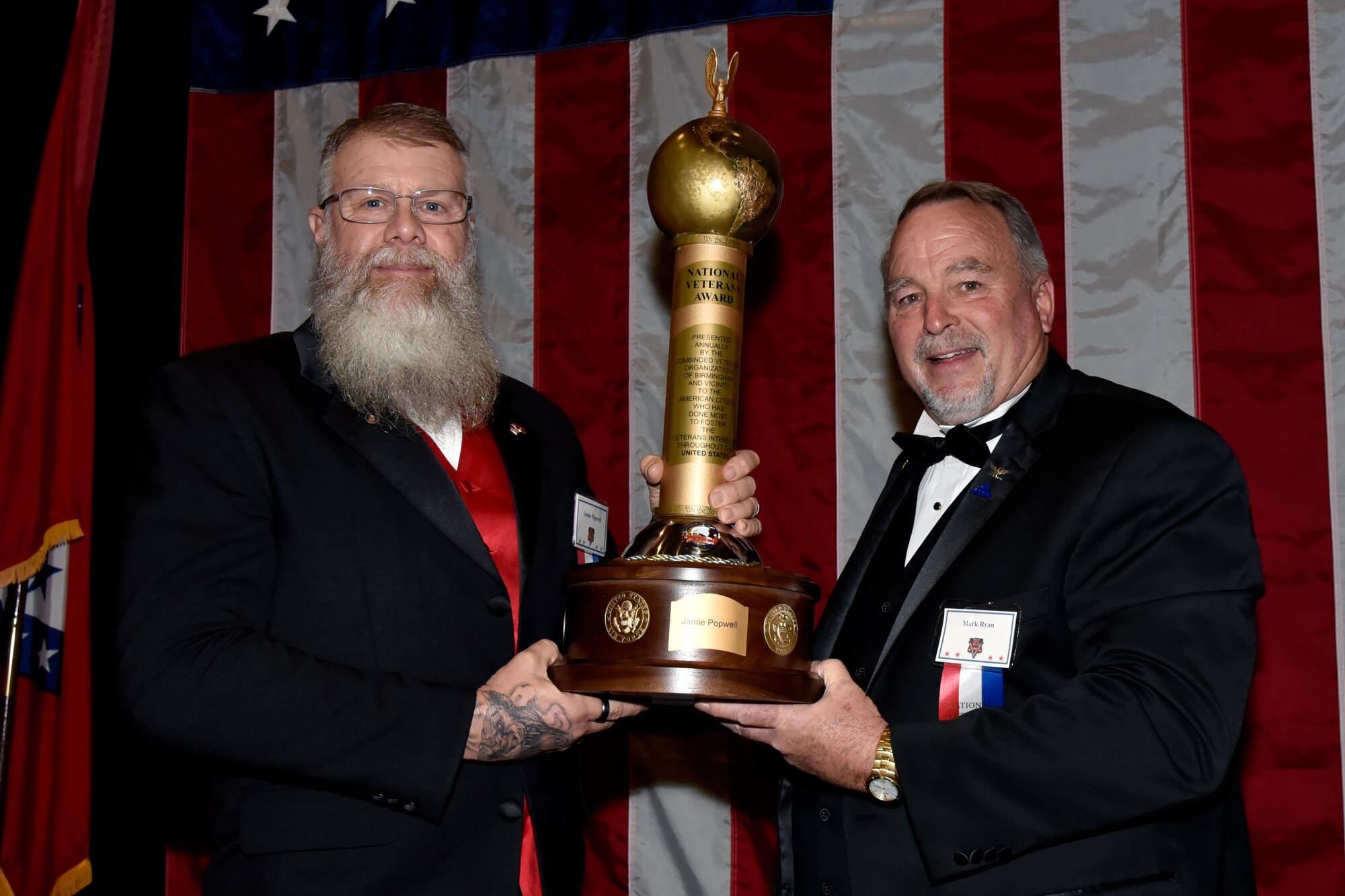 James Popwell, U.S. Marine Corps. veteran and founder of the Flags for Vets non-profit, receives the 2023 National Veteran of the Year Award during the 76th National Veterans Day awards dinner hosted by the National Veterans Day Foundation on Nov. 10, 2023, in Birmingham, Alabama. A perpetual National Veterans Award was created in Birmingham for America’s first official National Veterans Day observance on November 11, 1954 as authorized by Congress. Its purpose is to honor an outstanding veteran in the United States each year who has made the greatest contribution to further the patriotic interests of veterans and veteran organizations throughout the country; and the award is presented at the National Veterans Award Dinner in Birmingham. (U.S. Air National Guard photo by Staff Sgt. Shelby Thurman)