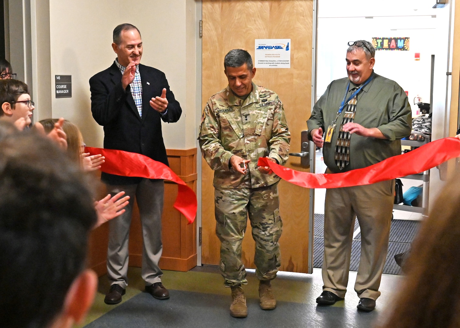 From left, STARBASE Director Mark Campbell, NH Adjutant Gen. David Mikolaities, and Franklin School District Superintendent Dan LeGallo conduct a classroom ribbon-cutting ceremony Nov. 13, 2023, at the New Hampshire National Guard’s Edward Cross Training Complex in Pembroke.