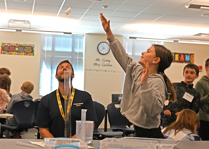 Principal Tim Vasconcellos and Leighton Filiau of Dunbarton Elementary School conduct an Alka-Seltzer rocket propulsion experiment Nov. 13, 2023, at the New Hampshire National Guard’s Edward Cross Training Complex in Pembroke.