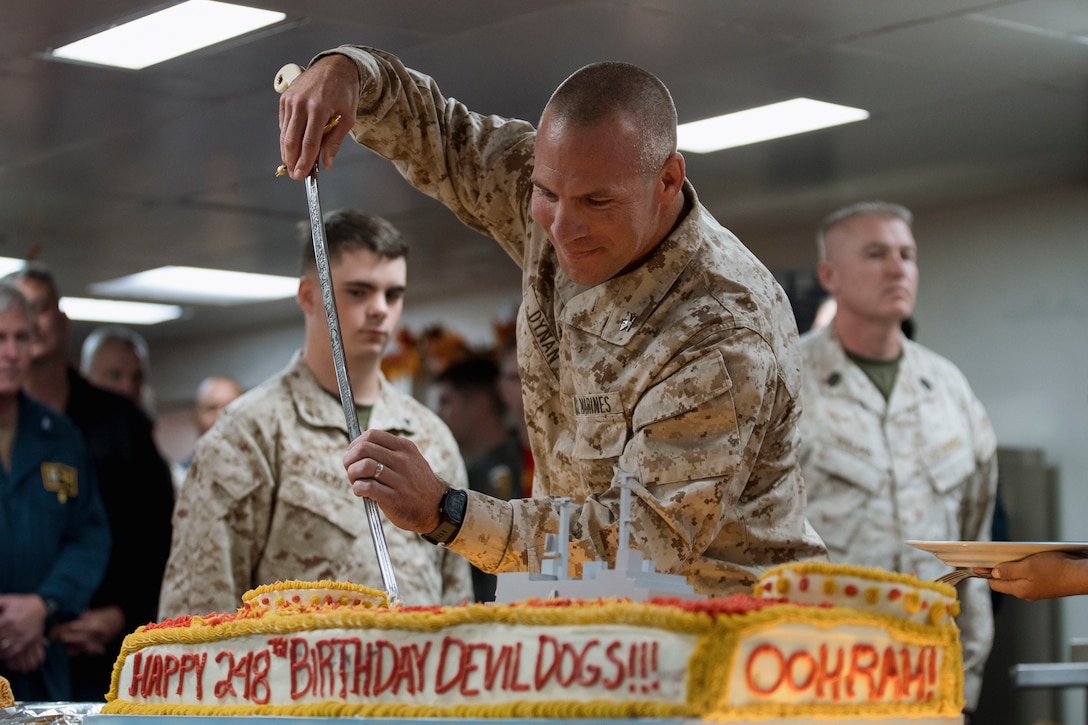 U.S. Marine Corps Col. Sean Dynan, commanding officer of the 15th Marine Expeditionary Unit, cuts the ceremonial birthday cake aboard the amphibious assault ship USS Boxer (LHD 4) in the Pacific Ocean, Nov. 10, 2023. The 15th MEU is currently embarked aboard the Boxer Amphibious Ready Group conducting integrated training and routine operations in U.S. 3rd Fleet. (U.S. Marine Corps photo by Cpl. Joseph Helms)