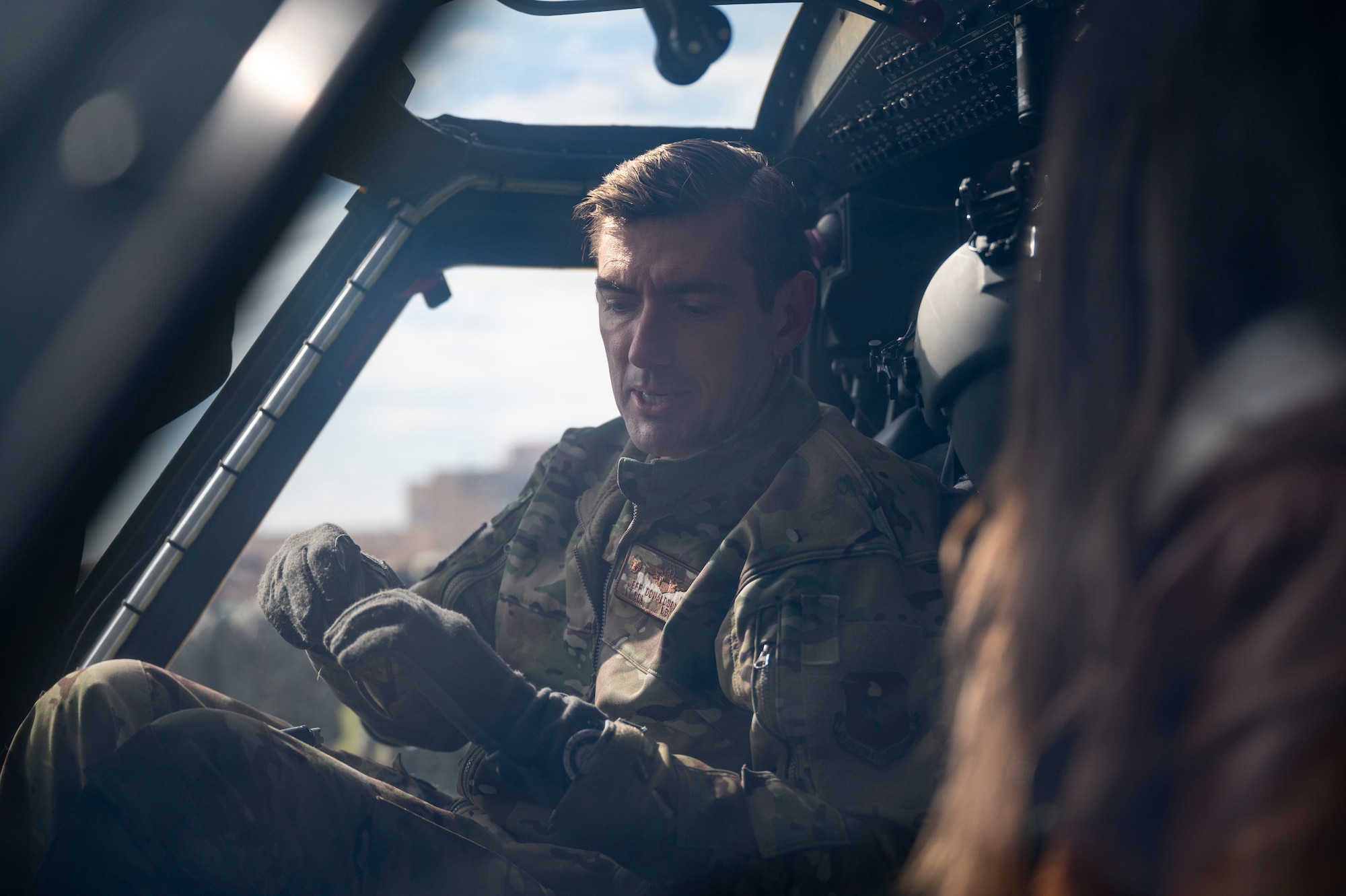 Man sits in cockpit with student