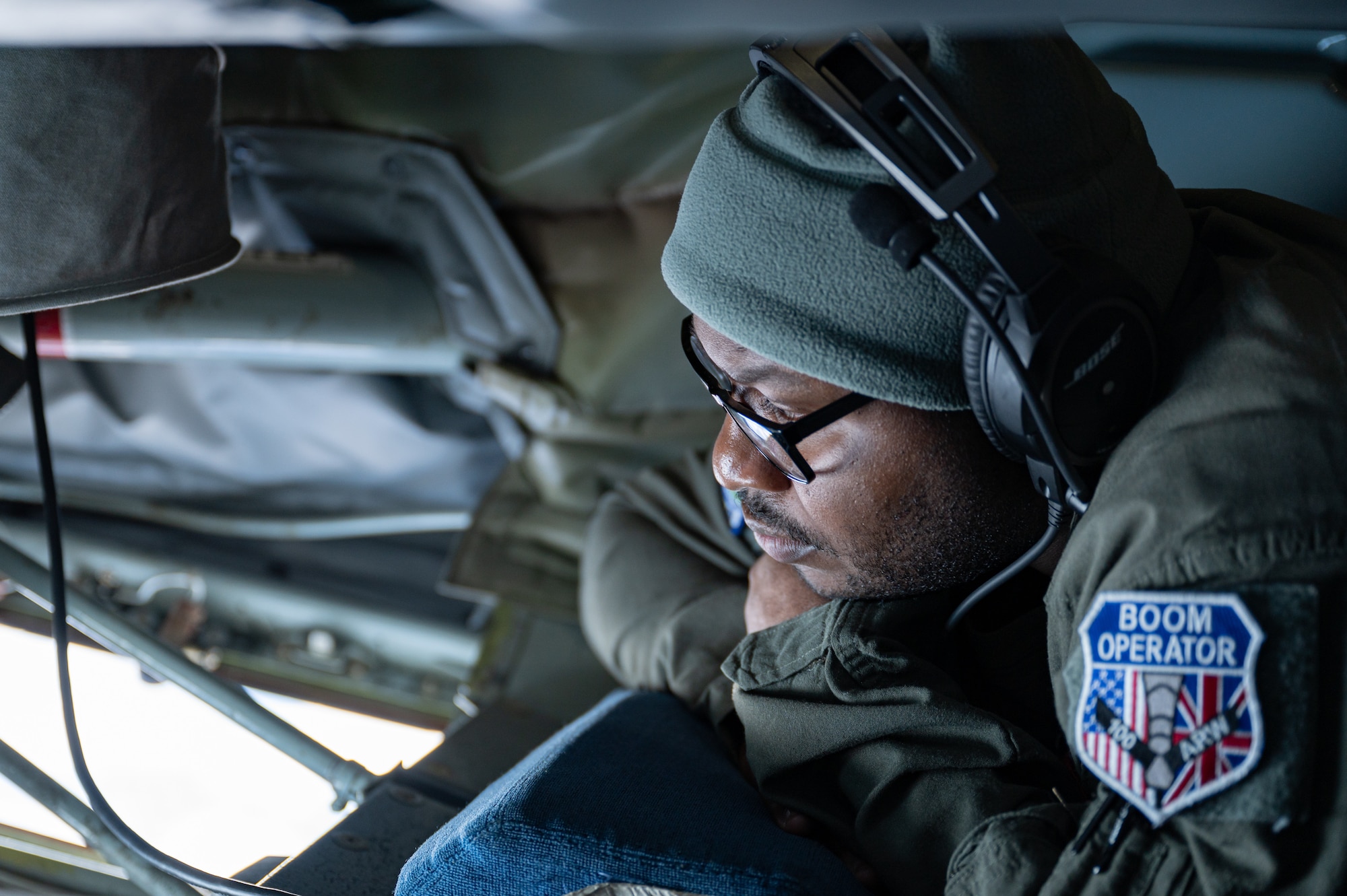 U.S. Air Force Tech Sgt. Fernando Brome, 351st Air Refueling Squadron KC-135 Stratotanker aircraft boom operator, looks out the boom pod window of a KC-135 during aerial refueling operations over the European area of responsibility, Nov. 8, 2023.