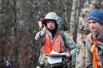 Civil Air Patrol Cadet Chief Master Sgt. Thomas Owens, a sixteen-year-old assigned to the Lake Hood Cadet Squadron in Anchorage, directs his team using land navigation skills during a three-day training event Nov. 4, 2023, at the Birchwood Airport in Chugiak, Alaska.