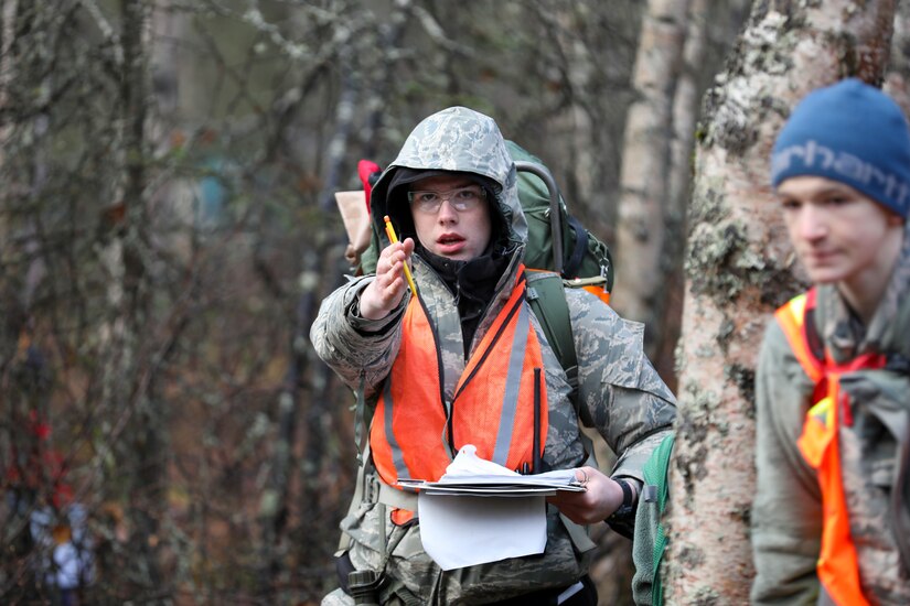 Civil Air Patrol Cadet Chief Master Sgt. Thomas Owens, a sixteen-year-old assigned to the Lake Hood Cadet Squadron in Anchorage, directs his team using land navigation skills during a three-day training event Nov. 4, 2023, at the Birchwood Airport in Chugiak, Alaska.