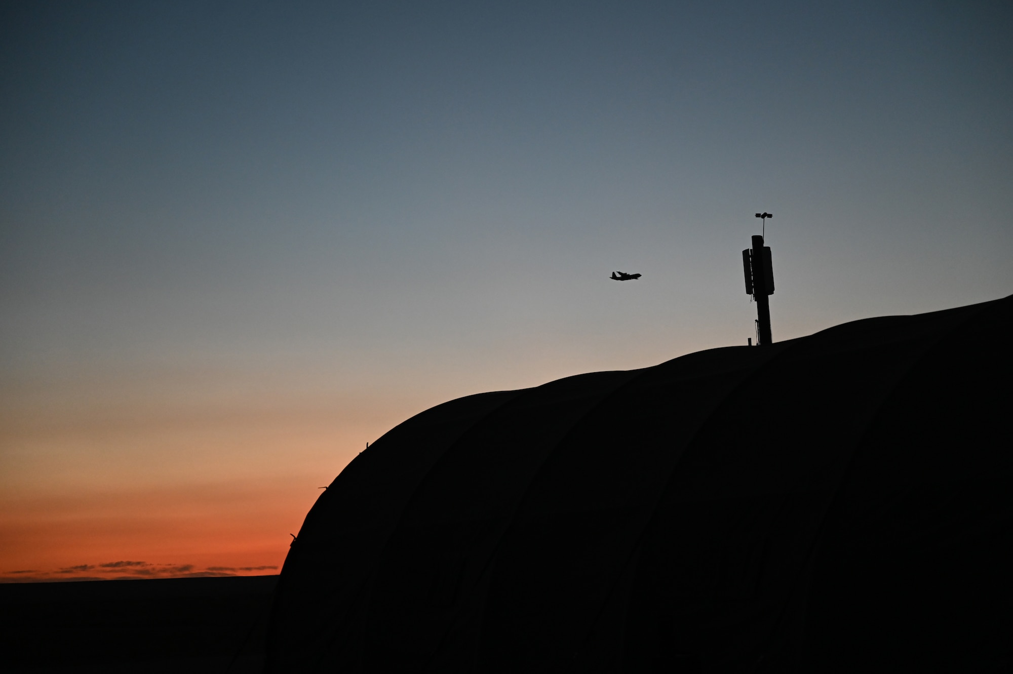 A C-130J Super Hercules flies at Melrose Range, New Mexico, Oct. 17, 2023, during exercise Dark Horizon. The exercise included mountain low-level formation flying, rapidly deploying tents and essential operating equipment and establishing reliable command and control at remote forward operating bases. (U.S. Air Force photo by Senior Airman Sophia Robello)