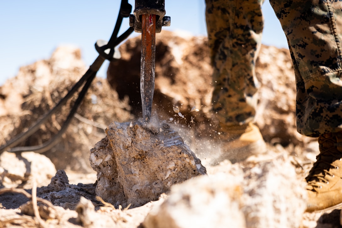 A U.S. Marine with 3d Littoral Logistics Battalion, 3d Marine Littoral Regiment, 3d Marine Division, uses a jackhammer during the construction of an obstacle course in preparation for KAMANDAG 7, at Camp Cape Bojeador, Philippines, Nov. 7, 2023. KAMANDAG is an annual Philippine Marine Corps and U.S. Marine Corps led exercise aimed at improving readiness, relationships, and mutual capabilities in the advancement of a Free and Open Indo-Pacific. This year marks the seventh iteration of this exercise and includes participants from Japan, the Republic of Korea, and observers from the United Kingdom. (U.S. Marine Corps photo by Cpl. Malia Sparks)