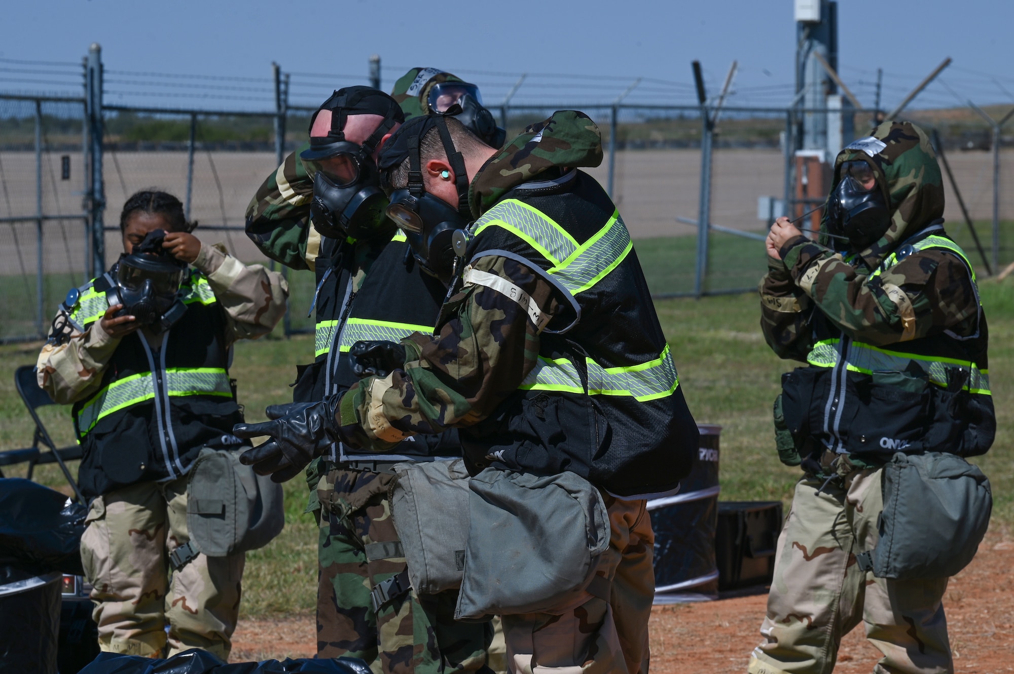 Members from the 317th Operation Support Squadron don Mission Oriented Protective Posture gear at Dyess Air Force Base, Texas, Oct. 18, 2023, during exercise Dark Horizon. Dark Horizon showcased various Agile Combat Employment operations, ensuring our forces stay agile enough to complicate and confuse enemy targeting. (U.S. Air Force photo by Senior Airman Sophia Robello)