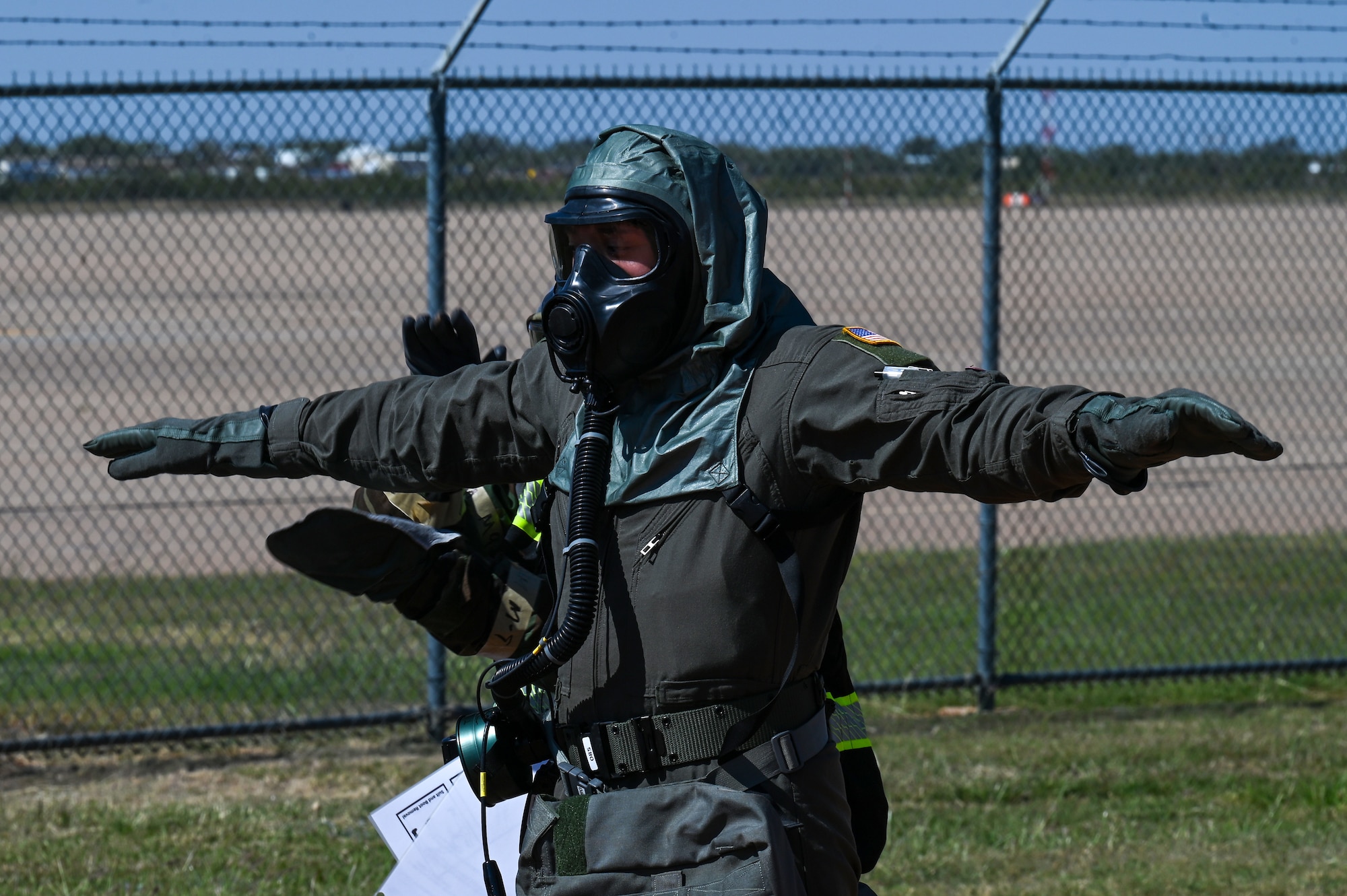 Senior Airman Darren Battle, 39th Airlift Squadron loadmaster, gets decontaminated during a simulated decontamination line at Dyess Air Force Base, Texas, Oct. 18, 2023, during exercise Dark Horizon. Agile Combat Employment exercises like Dark Horizon help protect personnel, equipment and facilities while keeping combat airlift operations intact. (U.S. Air Force photo by Senior Airman Sophia Robello)