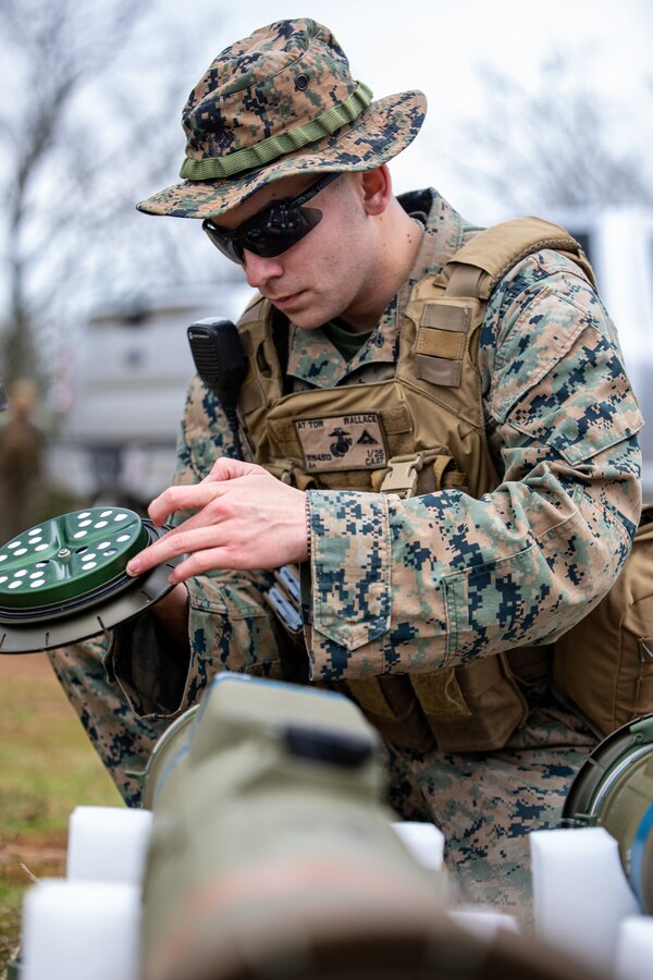 U.S. Marine Corps Lance Cpl. Samuel Wallace, an anti-tank missile gunner for Anti-Tank Training Company, 25th Marine Regiment, 4th Marine Division, Marine Forces Reserve inspects a Tube-Launched Optically-Tracked Wire-Guided (TOW) weapon system missile before a live-fire exercise at Fort Chaffee Joint Maneuver Training Center, Arkansas, March 3, 2023. The Marines fired the TOW weapon system from a Joint Light Tactical Vehicle (JLTV), to familiarize themselves with the safety and firing procedures associated with it. The JLTV family of vehicles comes in different variants with multiple mission package configurations, all providing protected, sustained, networked mobility that balances payload, performance, and protection across the full range of military operations. Wallace is a native of Muskogee, Oklahoma. (U.S. Marine Corps photo by Cpl. Jonathan L. Gonzalez)