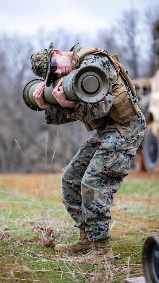 U.S. Marine Corps Lance Cpl. Samuel Wallace, an anti-tank missile gunner for Anti-Tank Training Company, 25th Marine Regiment, 4th Marine Division, Marine Forces Reserve inspects a Tube-Launched Optically-Tracked Wire-Guided (TOW) weapon system missile before a live-fire exercise at Fort Chaffee Joint Maneuver Training Center, Arkansas, March 3, 2023. The inspection of the missile is to ensure no foreign objects are inside before firing. The Marines of AT Company fired the TOW weapon system from a Joint Light Tactical Vehicle (JLTV) to familiarize themselves with the safety and firing procedures associated with it. Wallace is a native of Muskogee, Oklahoma. (U.S. Marine Corps photo by Cpl. Jonathan L. Gonzalez)