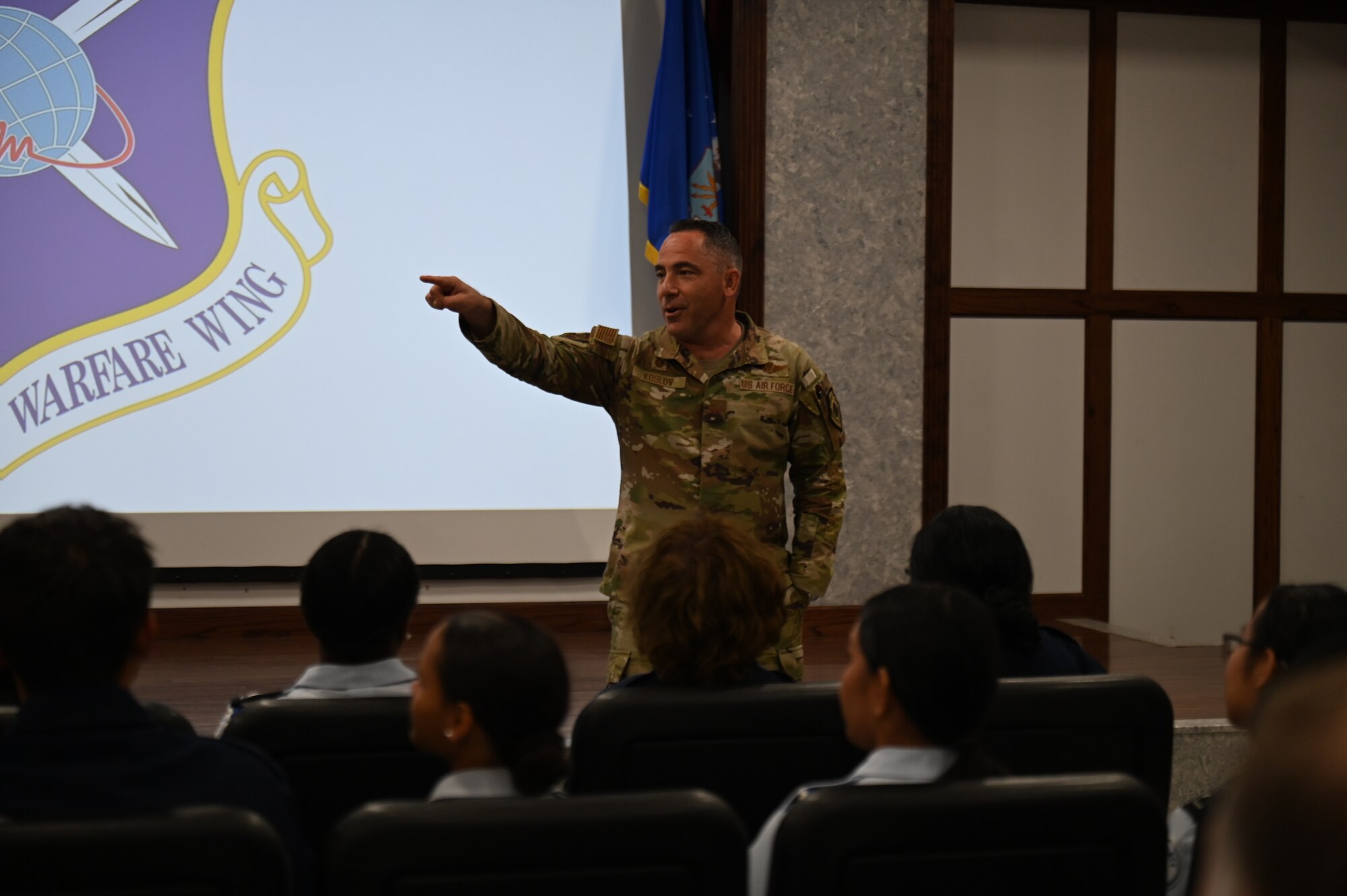 U.S. Air Force Col. Josh Koslov, 350th Spectrum Warfare Wing commander, briefs Pensacola High School Air Force JROTC cadets during a wing visit at Eglin Air Force, Fla., Nov. 1, 2023. Cadets visited the 350th SWW to learn more about the operational Air Force, the wing’s mission to provide expert Electronic Warfare support and attack as well as learn about future career opportunities. (U.S. Air Force photo by Capt. Benjamin Aronson)