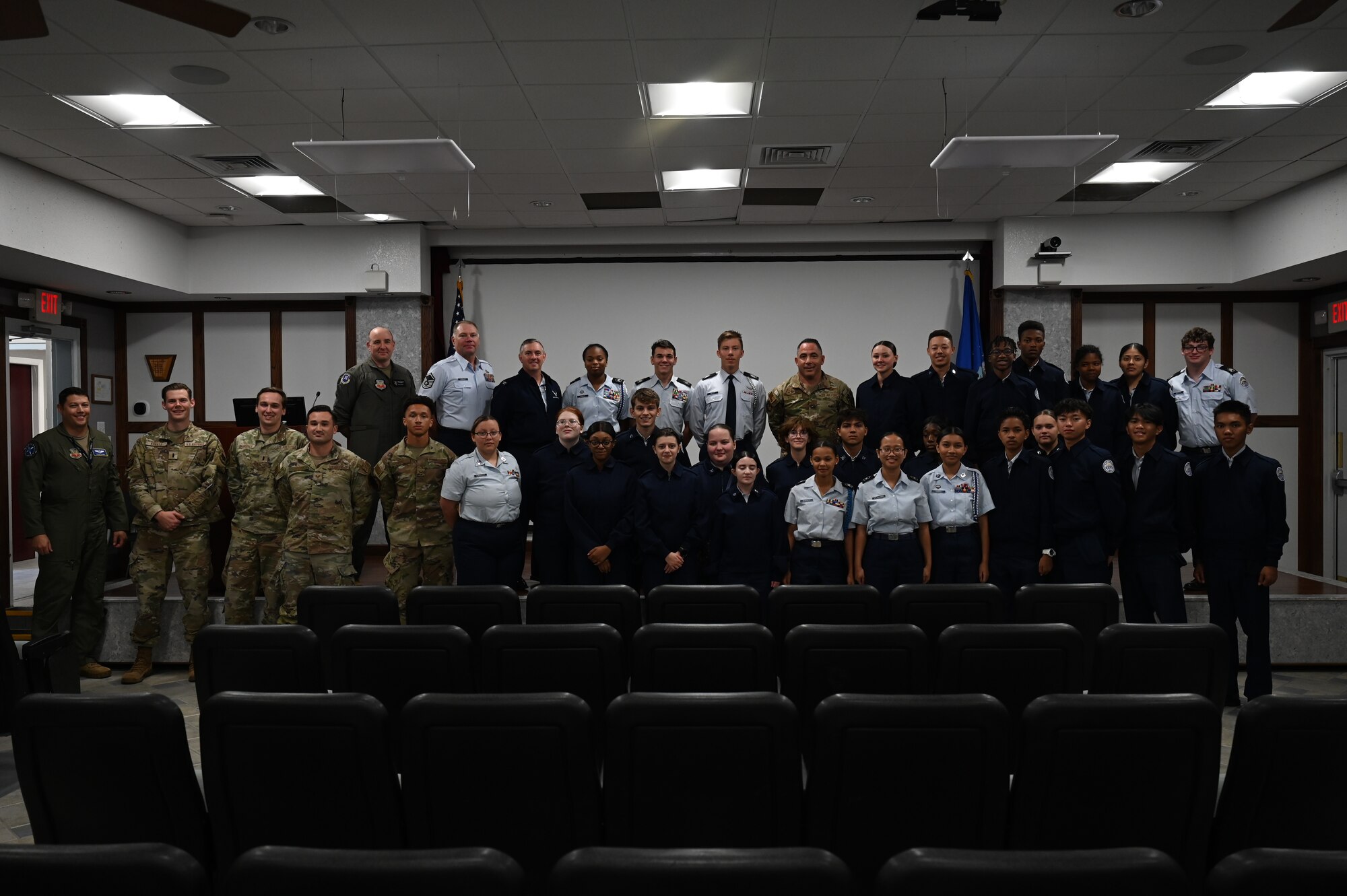 Members of the 350th Spectrum Warfare Wing and the Pensacola High School Air Force JROTC take a group photo at the conclusion of a wing tour at Eglin Air Force, Fla., Nov. 1, 2023. During the briefings, the cadets had the opportunity to talk with the wing commander and other wing members about their career fields and Air Force experiences. (U.S. Air Force photo by Capt. Benjamin Aronson)