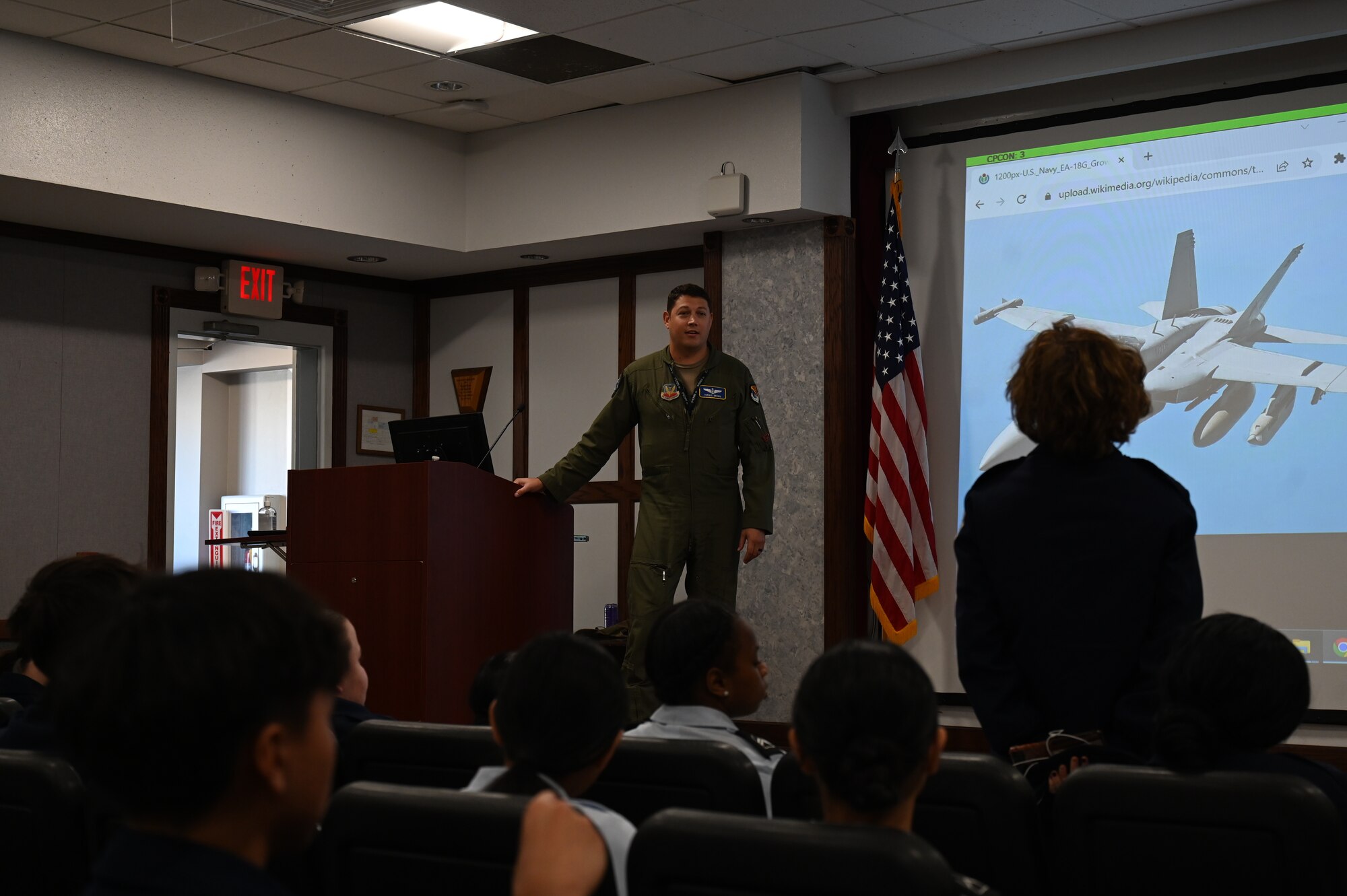 U.S. Air Force Maj. Seth Brown, 350th Spectrum Warfare Wing commander’s action group chief, briefs on the F-15E Strike Eagle and the Navy EA-18G Growler during a brief to Pensacola High School Air Force JROTC cadets during a wing tour at Eglin Air Force, Fla., Nov. 1, 2023. During the briefings, the cadets had the opportunity to talk with the wing commander and other wing members about their career fields and Air Force experiences. (U.S. Air Force photo by Capt. Benjamin Aronson)