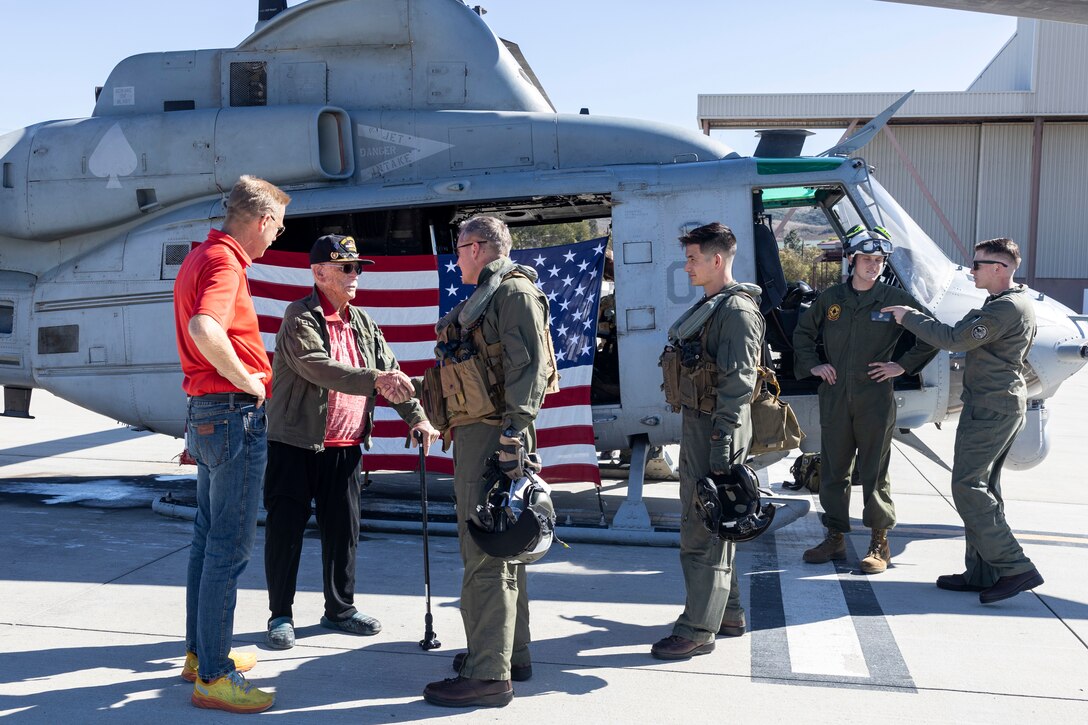 Retired U.S. Marine Corps and Army veteran Maj. Billy Hall, thanks the Marines of Marine Light Attack Helicopter Squadron (HMLA) 267, Marine Aircraft Group 39, 3rd Marine Aircraft Wing, after an honor flight in a UH-1Y Venom with HMLA-267, MAG-39, 3rd MAW, at Marine Corps Air Station Camp Pendleton, California, Nov. 11, 2023. The 97-year-old veteran of World War II, Korea, and Vietnam celebrated the 82nd anniversary of his Marine Corps Recruit Training graduation by flying with the Marines of HMLA-267. (U.S. Marine Corps photo by Sgt. Sean Potter)