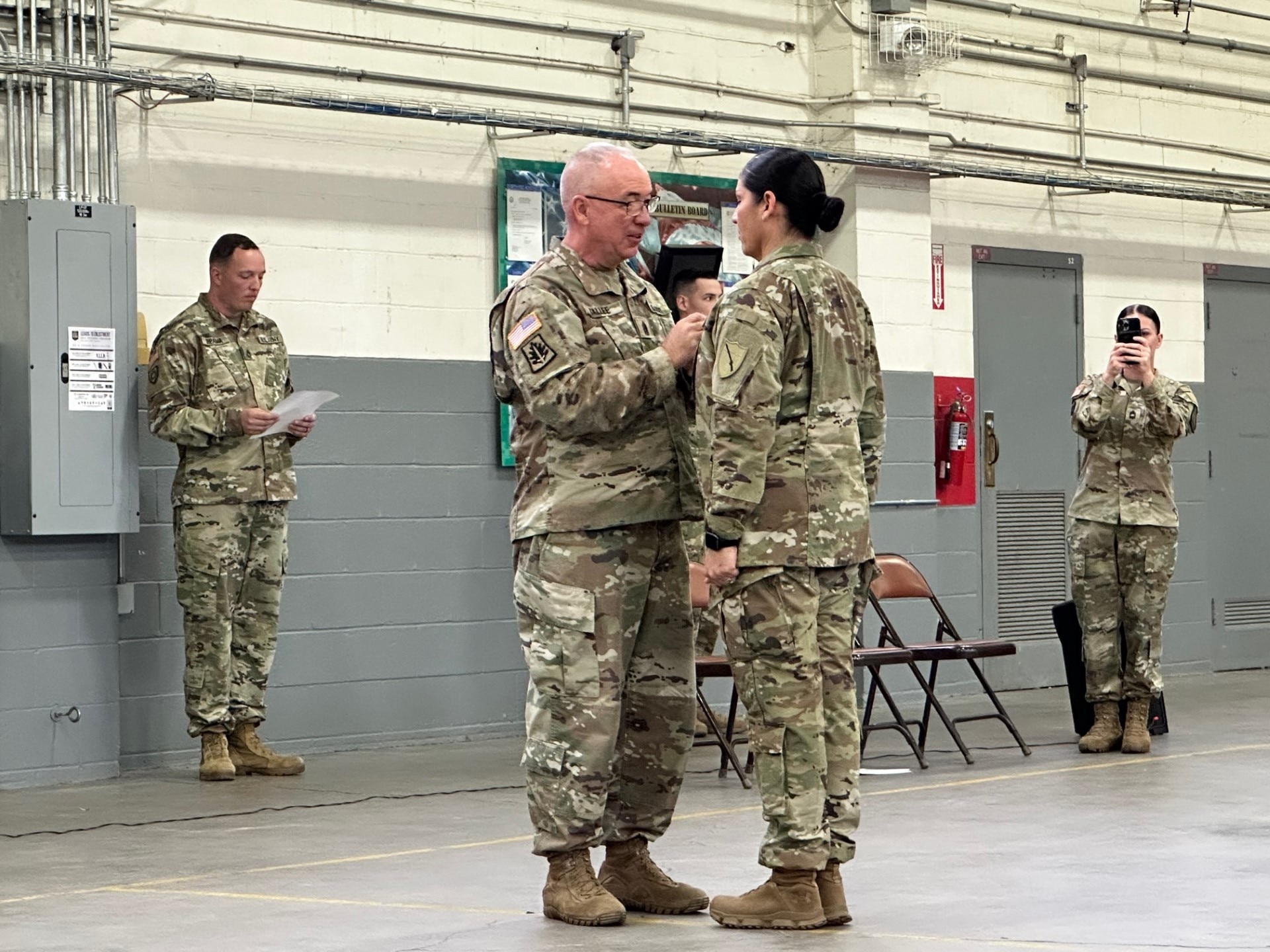 Army 1st Sgt. Naarah Stallard (right) is being pinned to sergeant major by Command Sgt. Maj. John D. Sallee, the retired sergeant major for the 198th Military Police Battalion at her promotion ceremony in Louisville, Kentucky on October 15, 2023. Stallard serves as the G-2 sergeant major for the Kentucky National Guard. (U.S. Army National Guard photo courtesy of Command Sgt. Maj. Naarah Stallard)
