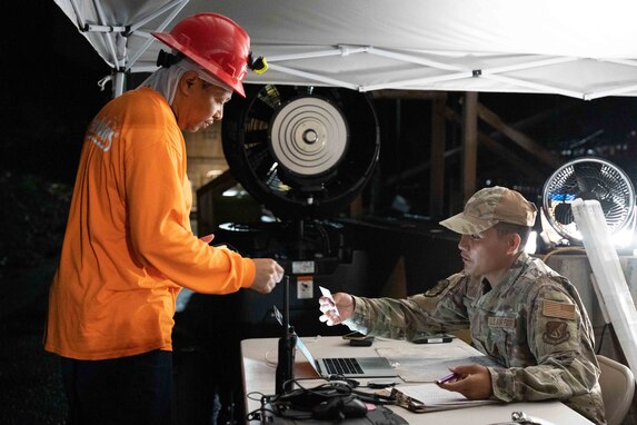 Joint Task Force-Red Hill (JTF-RH) Access Control Point team member, U.S. Air Force Senior Airman Brandon Murillo (right), monitors personnel during routine nighttime operations at Red Hill Bulk Fuel Storage Facility (RHBFSF), Halawa, Hawaii, Nov. 7, 2023.