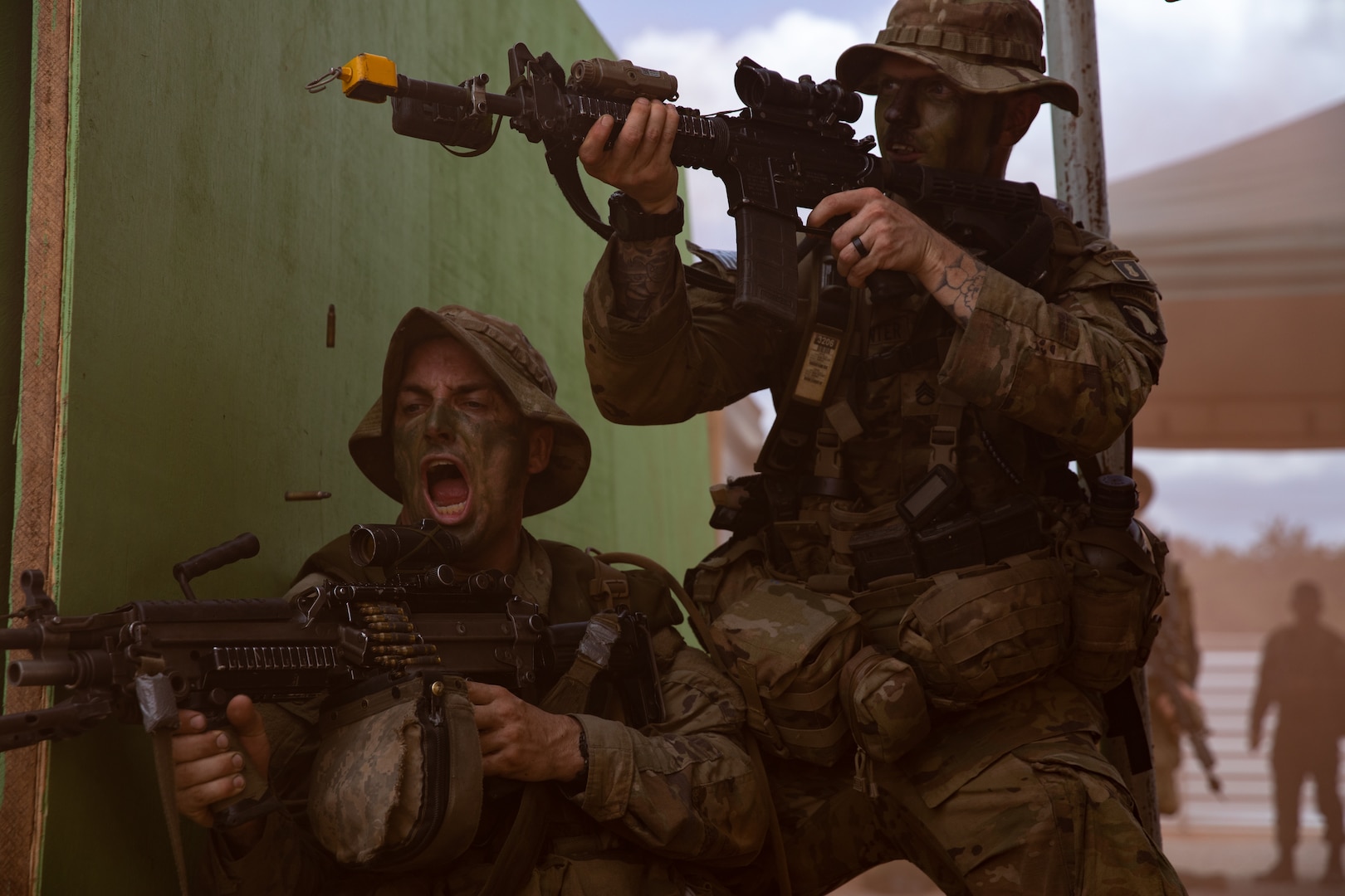 Soldiers fire on targets during a simulated attack.