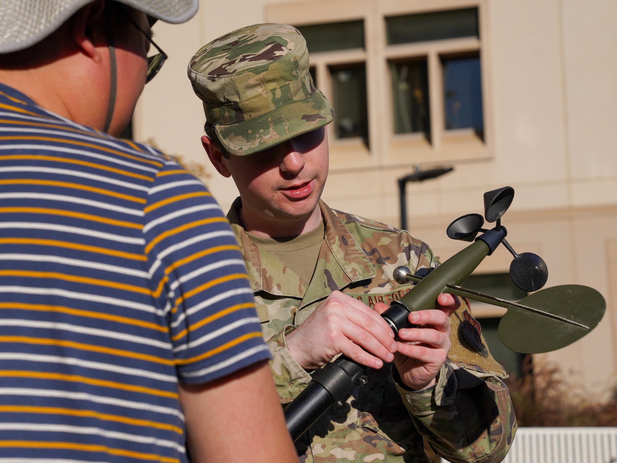 U.S. Air Force Tech Sgt. Zachary Cash, 9th Operations Squadron weather forecaster demonstrates a piece of the tactical meteorological observing system (TMOS) to students at the University of California, Davis, Nov. 07, 2023.